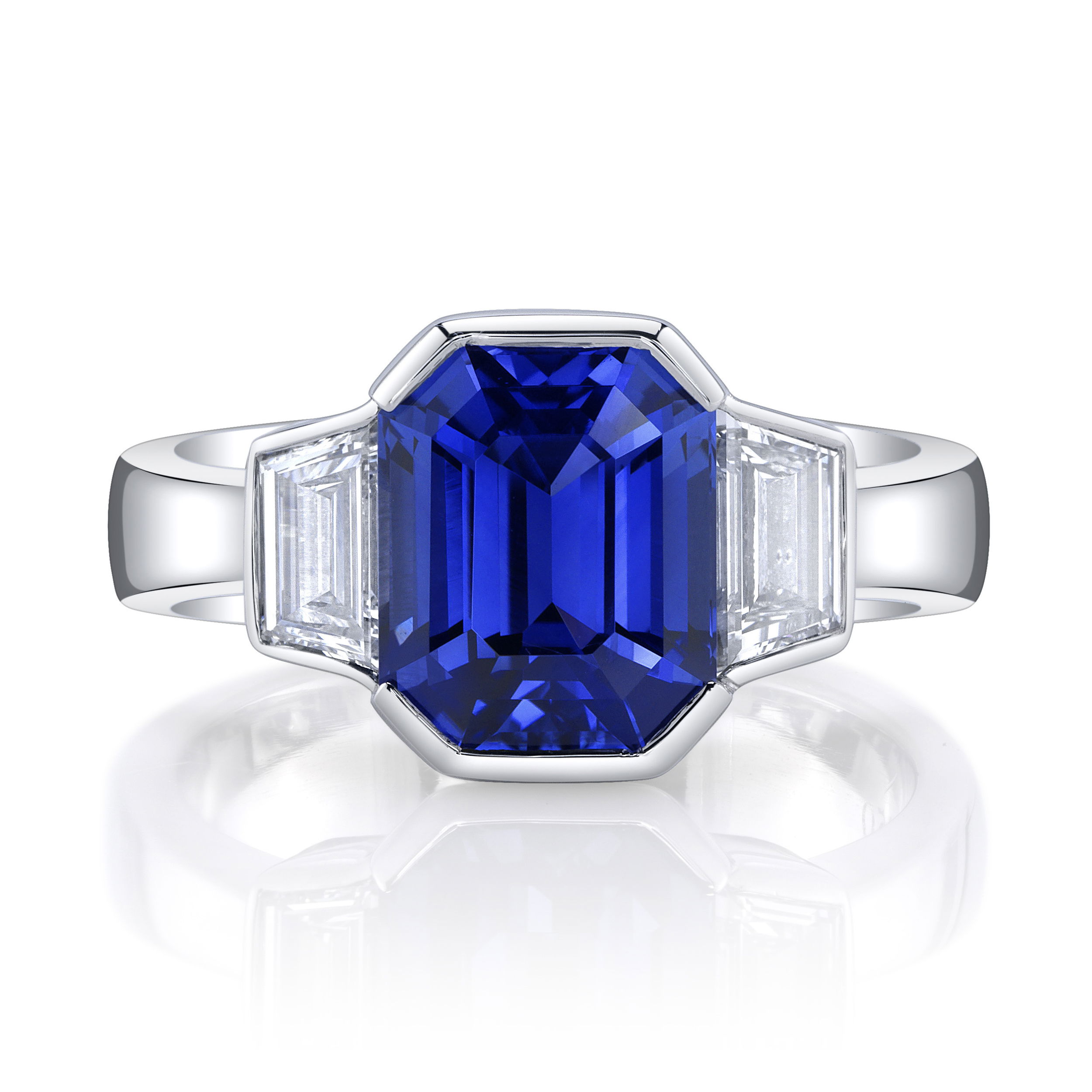 This stunning ring features a vibrant blue sapphire at its center, flanked by two brilliant diamonds, all set in sleek platinum. A timeless design, it offers a balance of elegance and sophistication, perfect for both special occasions and everyday luxury.-Platinum-Emerald cut blue sapphire, 4.60ct-Trapezoid diamonds, 0.93ctsItem# ND-Ring-00007 Saphiré Ring