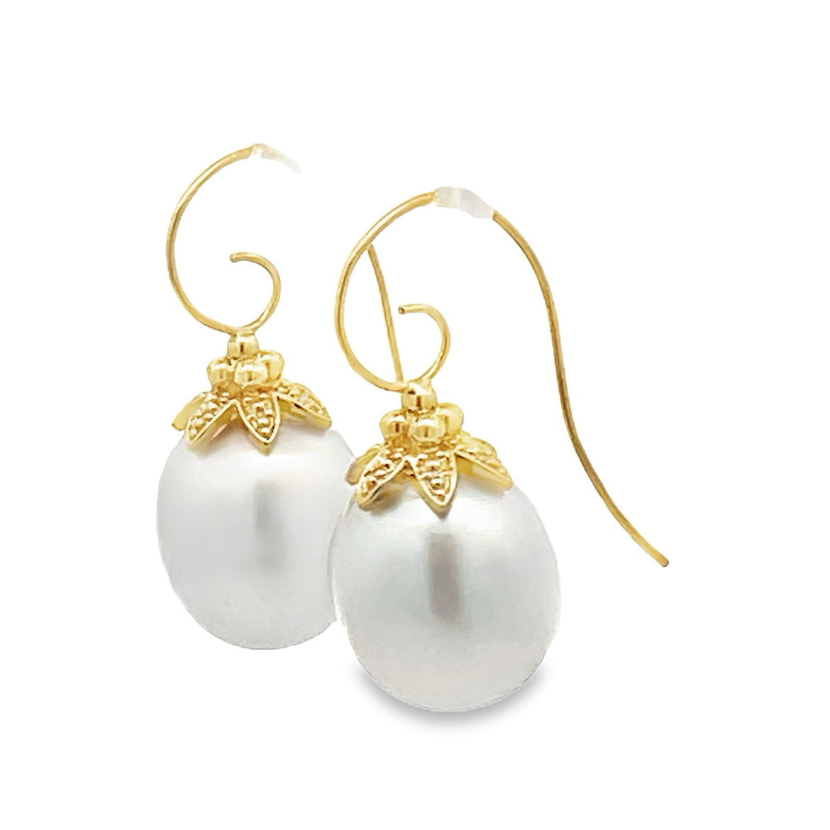 These South Sea white pearl earrings, set in 18k yellow gold, are a timeless blend of elegance and sophistication. Whether worn for a special occasion or every day, their luminous glow adds a classic touch to any look.-18k Yellow gold-South Sea White PearlsItem# ND-EAR-00012 Pearl and Flower Cap Earrings
