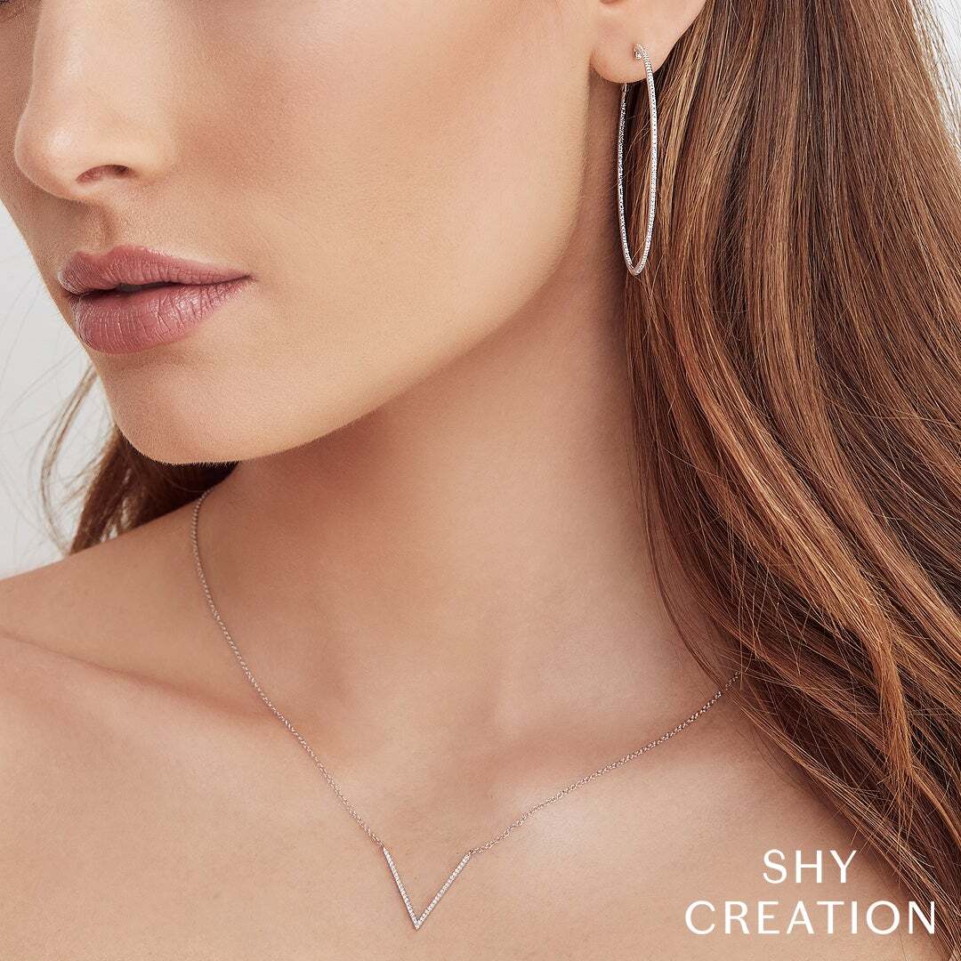 Add a touch of sparkle and elegance to your ensemble with these radiant and sophisticated hoops. Shy Creation diamonds are natural and hand-selected. All stones are unique and hand set. As a result, you can expect slight variations in the shade, hue, tint of the color stones and stone count.-14k White gold-Round diamonds, 0.66cts-Dimensions, 2.00" diameterItem# 805-2000305 Diamond Hoop Earrings
