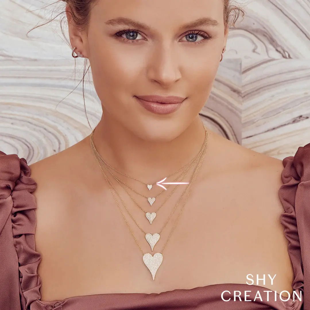 A great piece alone or to layer, this necklace is perfect for both everyday wear and special occasions. Shy Creation diamonds are natural and hand-selected. All stones are unique and hand set. As a result, you can expect slight variations in the shade, hue, tint of the color stones and stone count.-14k White gold-Round diamonds, 0.05cts-Chain length, 15"-18"Item# 807-2000223 Diamond Pave Heart Necklace