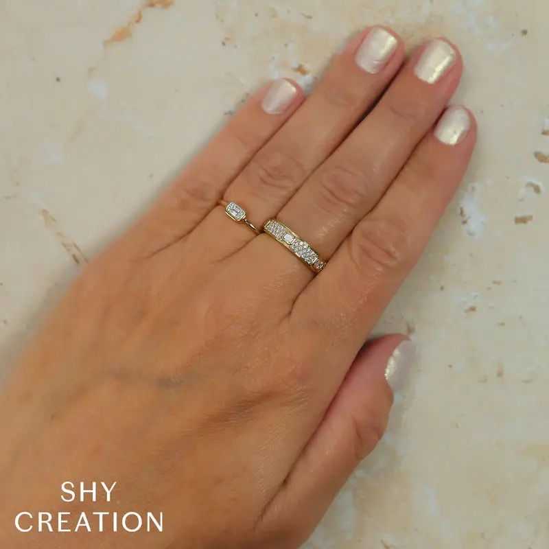 This elegant yellow gold ring features a striking combination of step-cut diamonds and round diamonds. Its sophisticated design offers a perfect balance of modern style and timeless elegance.-14k Yellow gold-Step-cut diamonds-Round diamonds, 0.49cts-Size 7 Contact for sizing options Item# 804-2000201 Mixed Cut Diamond Band