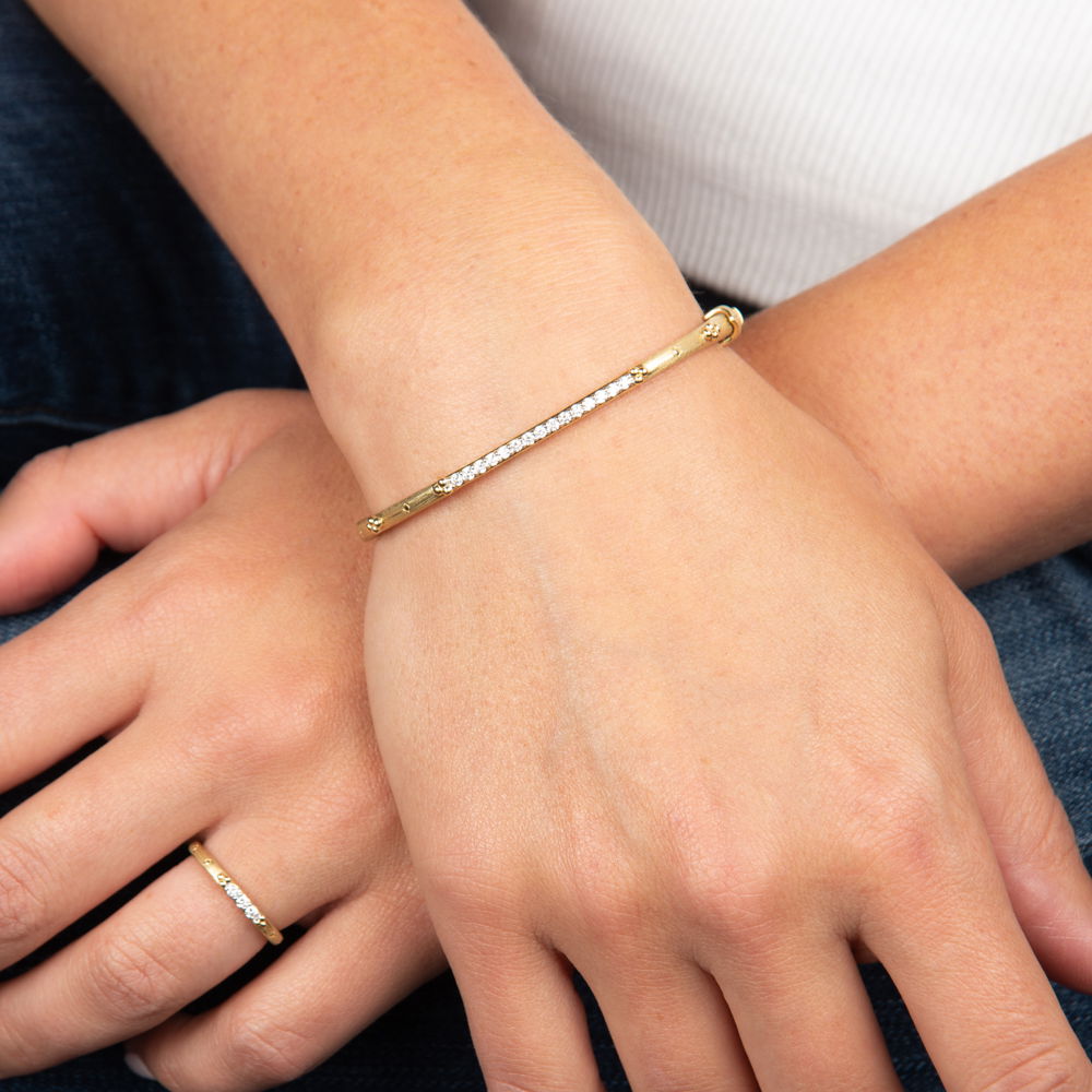 Combining classic elegance with on trend shapes and styles, JFJ offers something for women of all ages. From the Provence Collection, enhance your collection with bangles that seamlessly combine classic sophistication and contemporary style. Perfect for stacking or wearing solo, these versatile pieces add a touch of elegance to any outfit.-18k Yellow gold-Round white diamonds, 0.35cts-Dimensions, 2.5mm-Size, 6.5Item# 808-2000198 Diamond Line Bangle