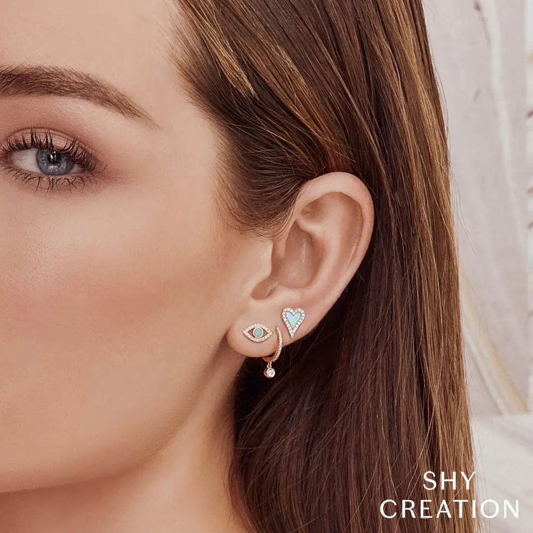 Lovely turquoise surrounded by sparkling diamonds and set in gold. Style them alone for a cute look any day of the week.-14k Gold-Heart design-Composite turquoise-Round diamond halo, 0.13cts-Post with small friction back-For pierced earsItem# 805-2000367 Turquoise Heart Studs