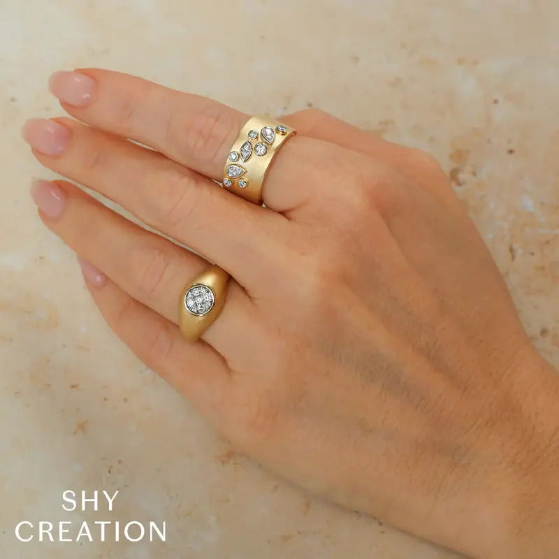 This modern cigar band is composed of yellow gold and diamonds set in marquise and pear shaped bezels. This ring has a soft matte finish to add texture to the overall look. -14k Yellow gold-Round diamonds set in various shaped bezels, 0.26cts-Matte finish on front of ring-Size 7, contact for sizing optionsItem# 804-2000215 Bezel Set Cigar Band
