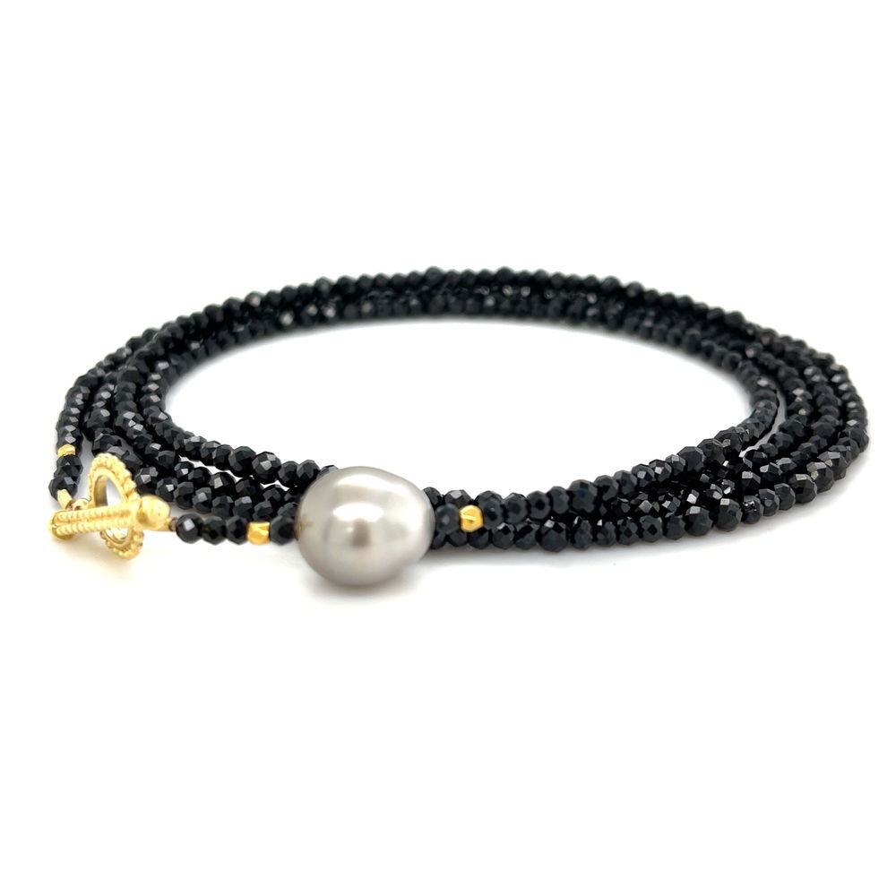 This black wrap bracelet with 18k yellow gold and a stunning Tahitian pearl brings a stylish, sophisticated touch to any outfit. It’s versatile too—wear it as a long necklace or layered for a different look. Pair it with an Empress Pendant to elevate your style and create even more unique combinations.-18k Yellow gold-Trilliant tahitian pearl-Length 33.5”. Contact for sizing options.Item# 808-00985 Tahitian Pearl Convertible Wrap Bracelet 32.5"