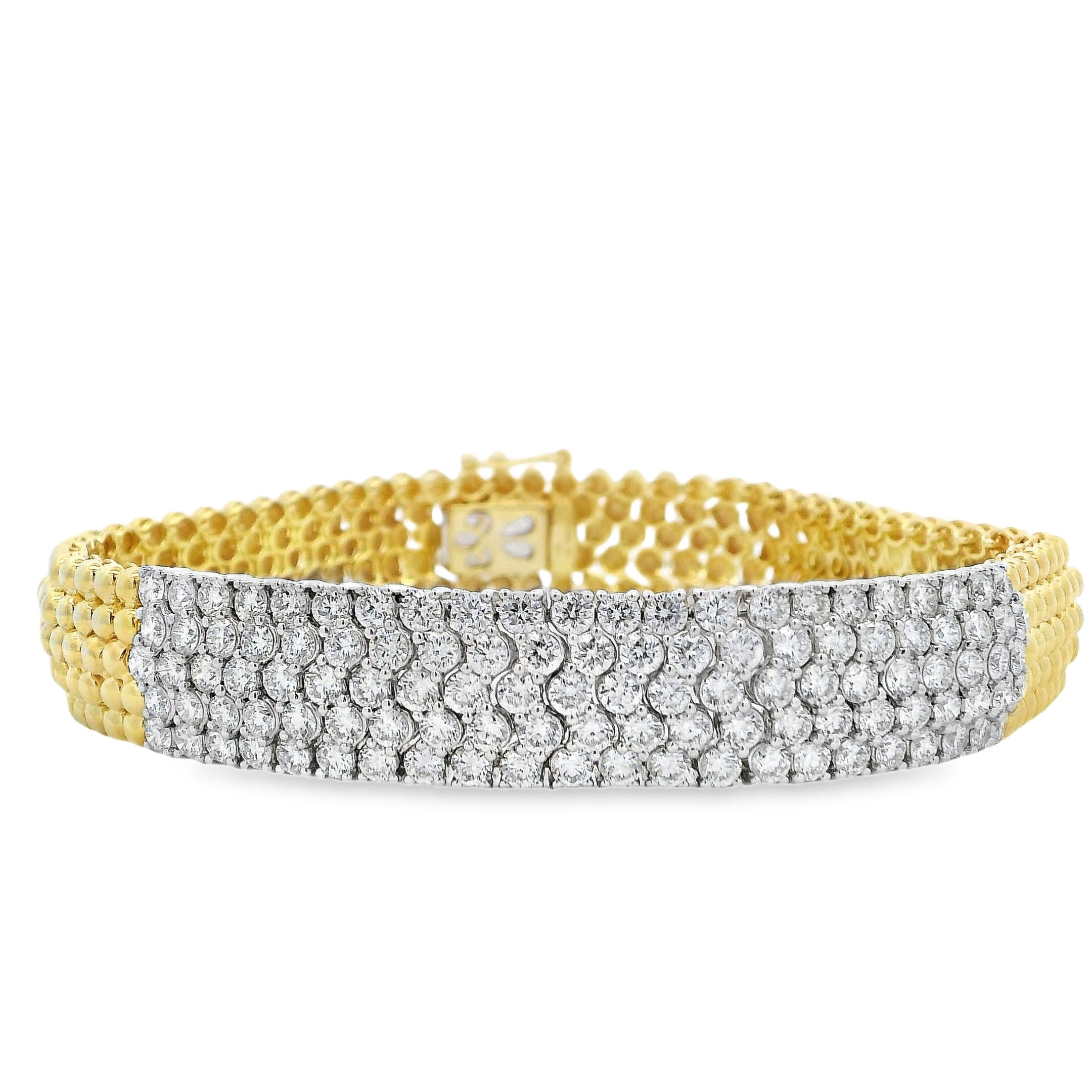 This striking bracelet features a bold centerpiece of pave set diamonds, creating a brilliant display of light and texture. Its sleek design and high-impact sparkle make it a standout piece for any jewelry collection.-14k Yellow and White gold-Round diamonds, 5.08cts-SizeItem# 808-2000212 Pave Diamond Bracelet