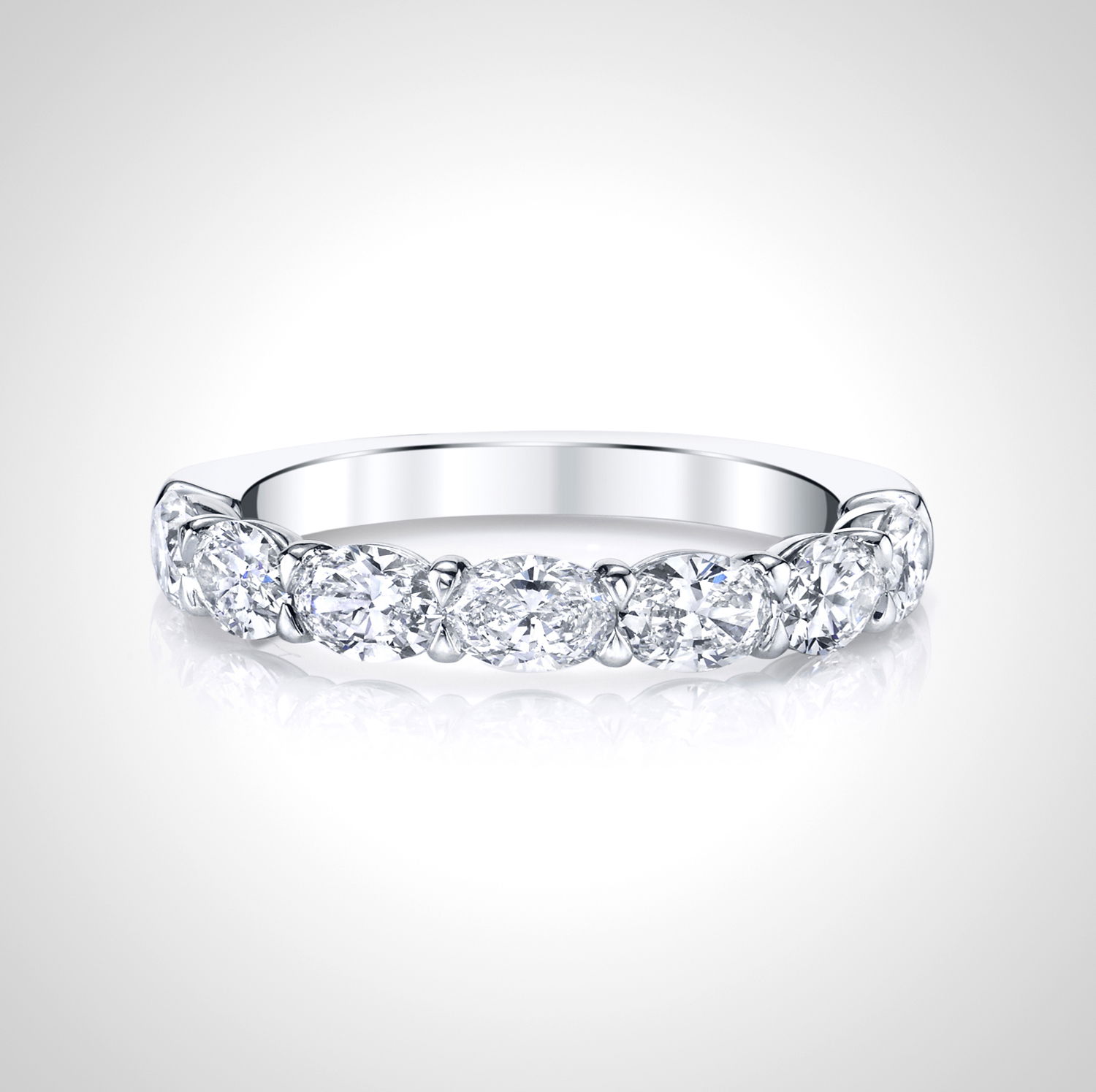 Modern yet timeless, this 18K white gold anniversary band features oval diamonds set east to west for a fresh, sophisticated look. A distinctive design that celebrates lasting love with contemporary flair.-18k White gold-Oval diamonds, 1.31cts-Size 6.5, Contact for sizing optionsItem# 110-2000037 Oval Anniversary Band