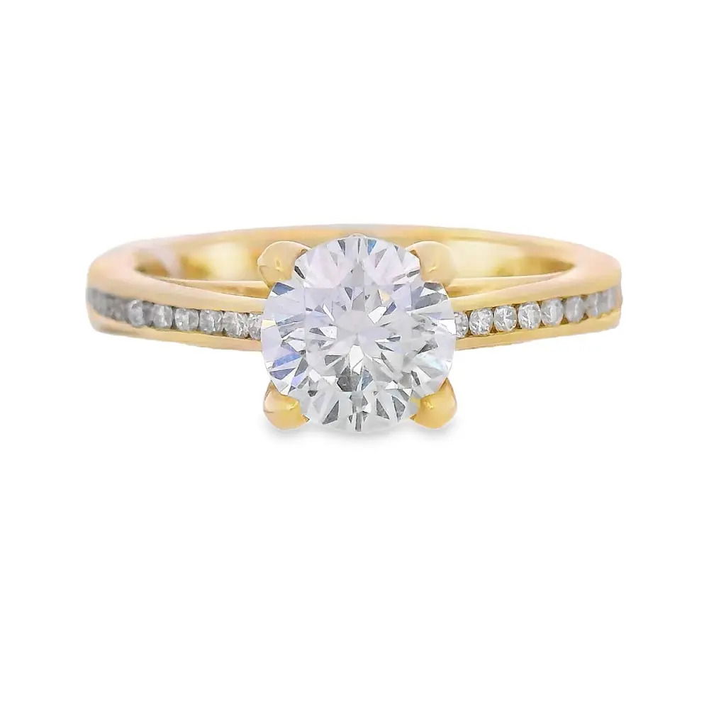 This cathedral semi-mount in 18k Yellow gold features channel set diamonds along the band, offering a sleek and sophisticated look. The raised cathedral setting provides a graceful lift to showcase your center stone, while the secure channel setting adds brilliance and durability. (Center stone not included)-18k Yellow gold-Round Diamonds, 0.21cts-Size 6.5, Contact for sizing optionsItem# 140-2000024 Round Channel Semi-Mount
