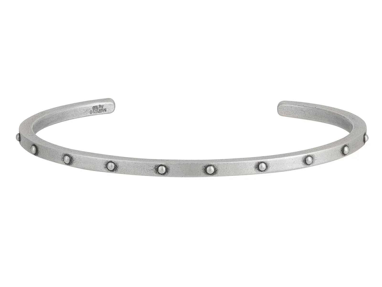 This narrow sterling silver cuff is accented with spaced rivets, offering a subtle yet bold design. Its sleek and versatile style makes it perfect for everyday wear.-Sterling silver-Width: 2.85 mm-Diameter 63.20x46mmItem# 800-2000051 Spaced Riveted Silver Cuff