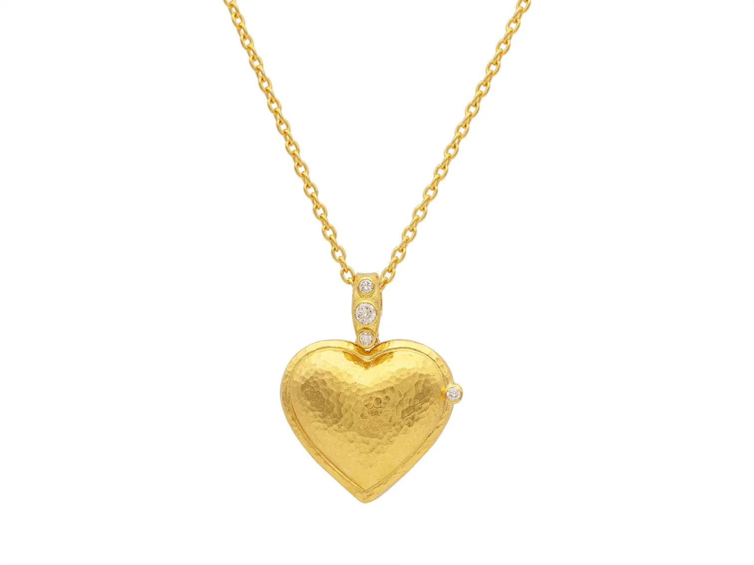 This 18k yellow gold heart locket necklace sparkles with diamonds, adding a touch of charm to any look. It’s a perfect piece to wear solo or layer for extra flair.-18k Yellow gold-Round diamonds, 0.20cts-Length 16-18"Item# 807-2000288 Heart Locket Necklace