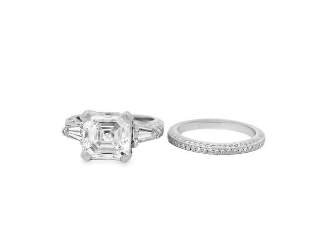 Designed by Tacori, this exquisite bridal set is in Platinum and features a 3.07ct Asscher cut center diamond in a timeless three-stone setting. Flanked by complementary side stones and paired with a matching wedding band, this set blends classic elegance with Tacori’s signature handcrafted detail. A stunning symbol of commitment and style.-Platinum-Asscher cut diamond, 3.07cts-Size 4, Contact for sizing optionsItem# 100-2000036 Asscher Cut Bridal Set