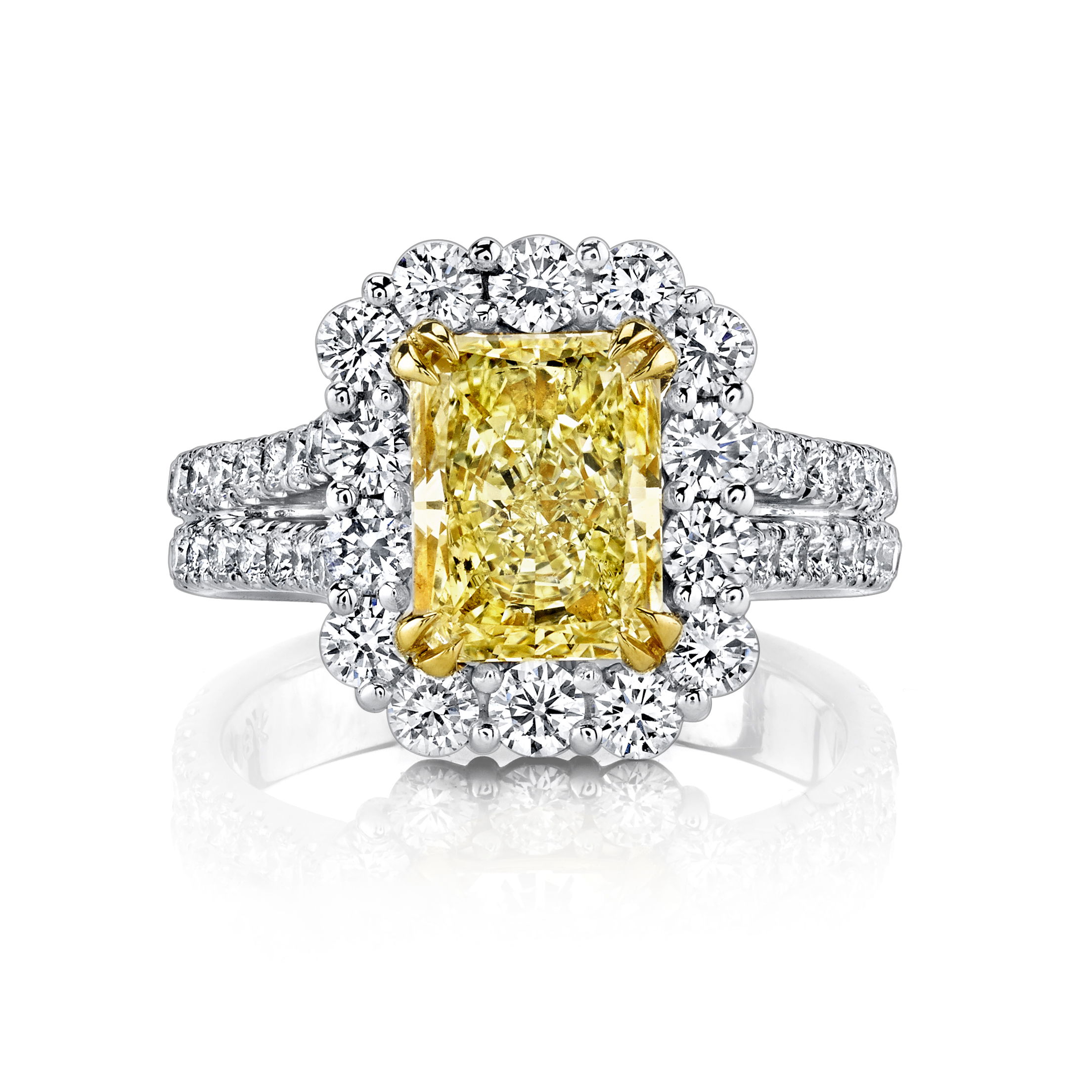 This halo engagement ring features a vibrant radiant cut yellow diamond at its center, surrounded by a sparkling halo that enhances its brilliance and color. Set in a timeless design, this ring offers a perfect balance of bold elegance and refined craftsmanship—an unforgettable symbol of love.-Platinum-18k Yellow gold-Radiant yellow diamond, 1.01ct-Round white diamonds, 1.18cts-Size, 6.5; contact for sizing optionsItem# 130-2000042 Yellow Diamond Engagement Ring