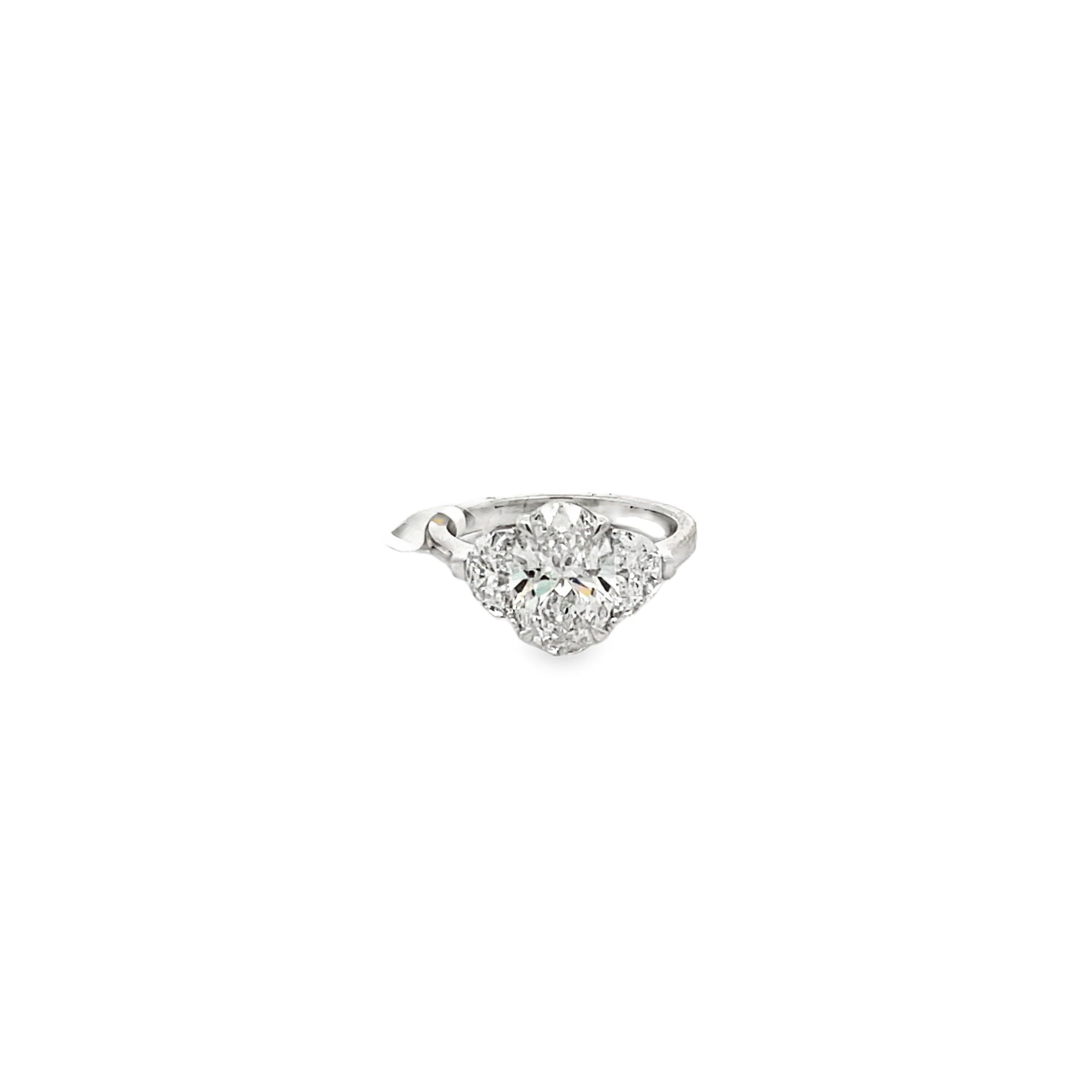 A perfect blend of elegance and modern craftsmanship, this 3-stone ring showcases a lab grown oval center diamond set in 14k White gold. It is enhanced by two lab grown half moon diamonds offering unmatched beauty and quality for your special moment.-14kt White gold-Oval lab grown diamond, 2.11cts-Half moon lab grown diamonds, 0.94cts-Size 6.5, Contact for sizing optionsItem# 100-2000043 Three Stone Engagement Ring