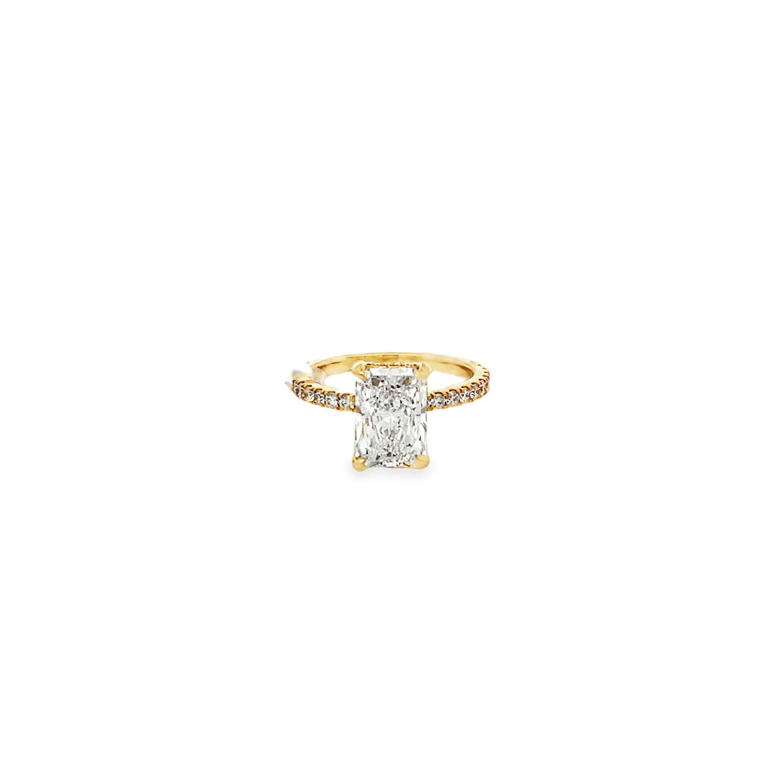 This stunning 14k yellow gold engagement ring features a 2.62ct radiant cut lab-grown diamond, set with a hidden halo and diamond-accented shank for an extra touch of sparkle. Its elegant design and exceptional quality make it the perfect choice for a timeless symbol of your love.-14k Yellow Gold-Radiant cut lab grown diamond, 2.62cts-Round lab grown diamonds, 0.58cts-Size 6.5, Contact for sizing optionsItem# 100-2000044 Hidden Halo Engagement Ring