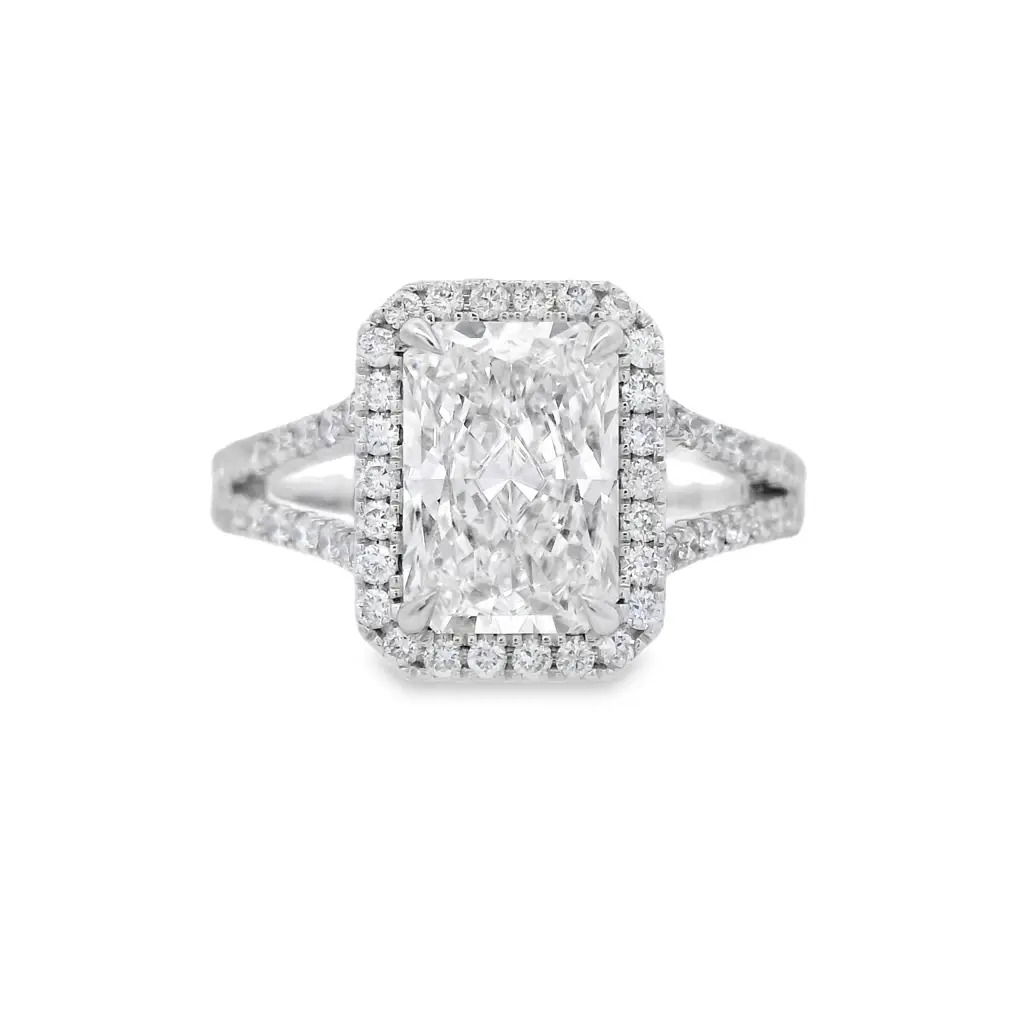 This 14kt white gold engagement ring showcases a stunning radiant cut lab-grown diamond, beautifully accented by a halo and split shank design. The combination of modern elegance and timeless craftsmanship makes this ring a perfect choice for your special moment.-14k White gold-Radiant lab grown diamond, 2.06cts-Round lab grown diamonds, 0.56cts-Size 6.5, Contact for sizing optionsItem# 100-2000045 Radiant 2.06ct Split Band Engagement