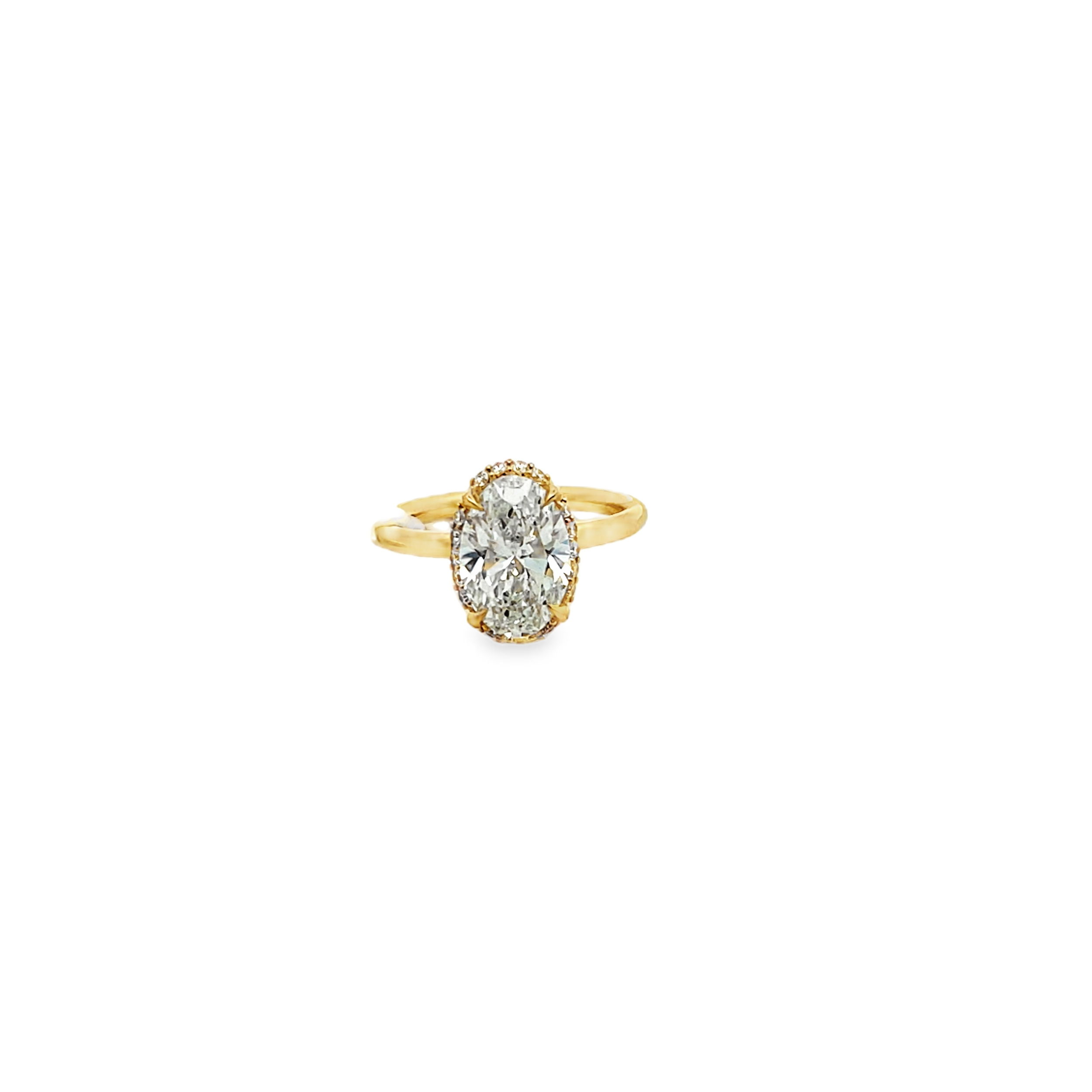 This exquisite 14k yellow gold engagement ring features a 2.69ct oval lab-grown diamond surrounded by a semi-hidden halo for added brilliance. The sleek, plain gold shank offers a timeless finish, making this ring a perfect symbol of love and commitment.-14k Yellow gold-Oval lab grown diamond, 2.69cts-Round lab grown diamonds, 0.19cts-Size 6.5, Contact for sizing optionsItem# 100-2000047 Hidden Halo Engagement Ring