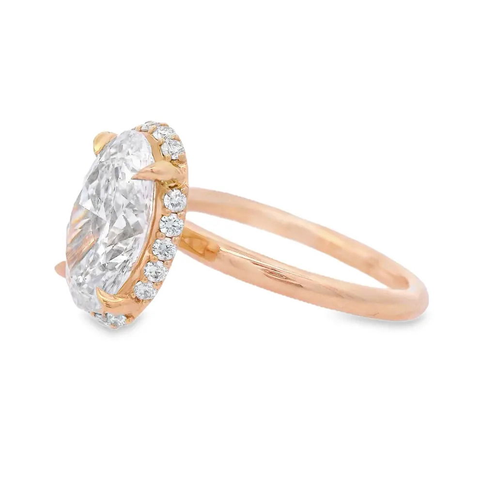 This exquisite 14k yellow gold engagement ring features a 2.69ct oval lab-grown diamond surrounded by a semi-hidden halo for added brilliance. The sleek, plain gold shank offers a timeless finish, making this ring a perfect symbol of love and commitment.-14k Yellow gold-Oval lab grown diamond, 2.69cts-Round lab grown diamonds, 0.19cts-Size 6.5, Contact for sizing optionsItem# 100-2000047 Oval 2.69ct Hidden Halo Engagement
