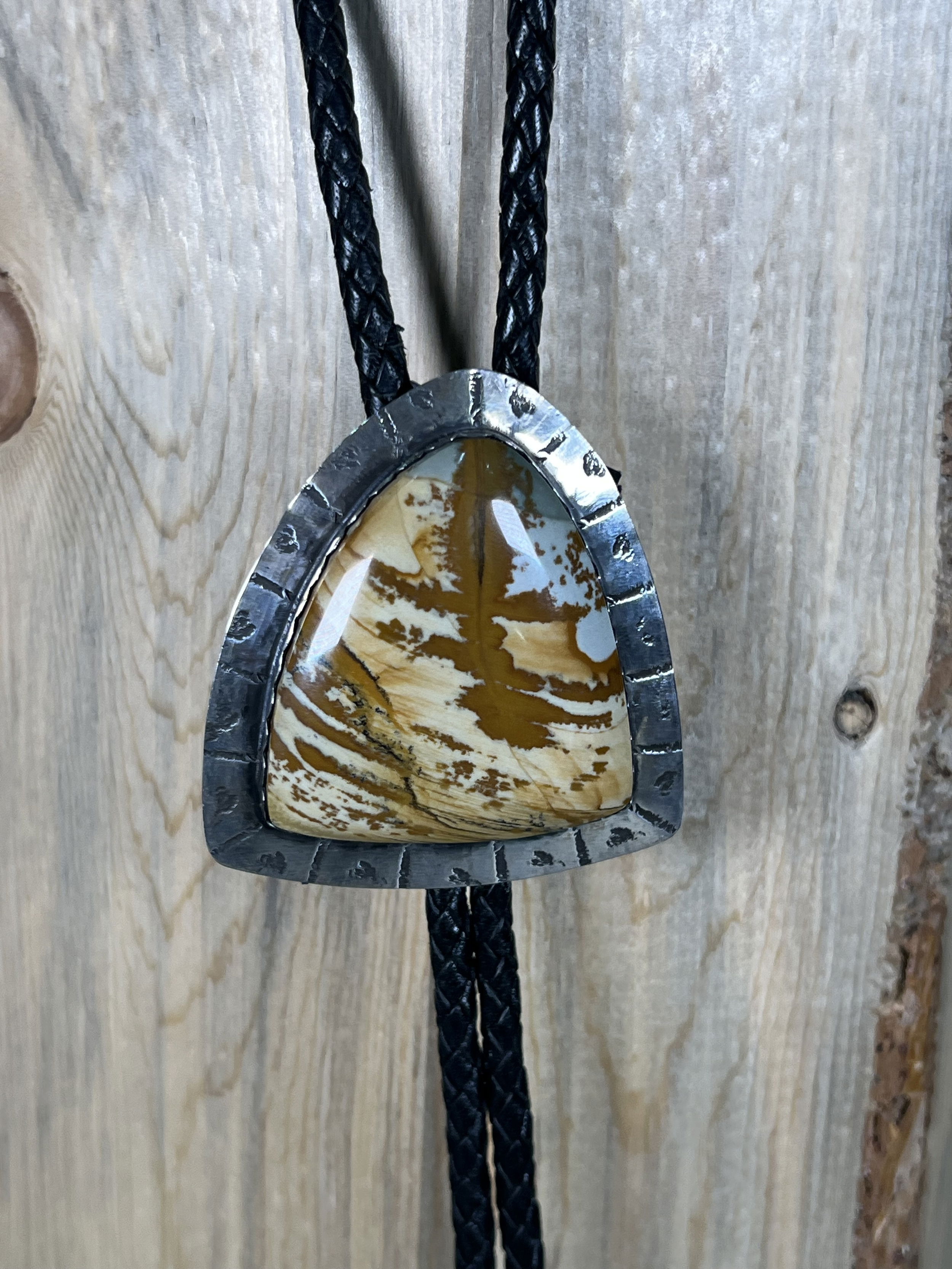 Elevate your style with our Desert Majesty Jasper Bolo. Hand-crafted locally, this unique bolo tie features a stunning jasper stone set in sleek, silver hardware. Add a touch of sophistication to any outfit with this luxurious accessory that will surely make a statement.-Sterling silver-Jasper-LeatherItem# 51538232 Desert Majesty Jasper Bolo