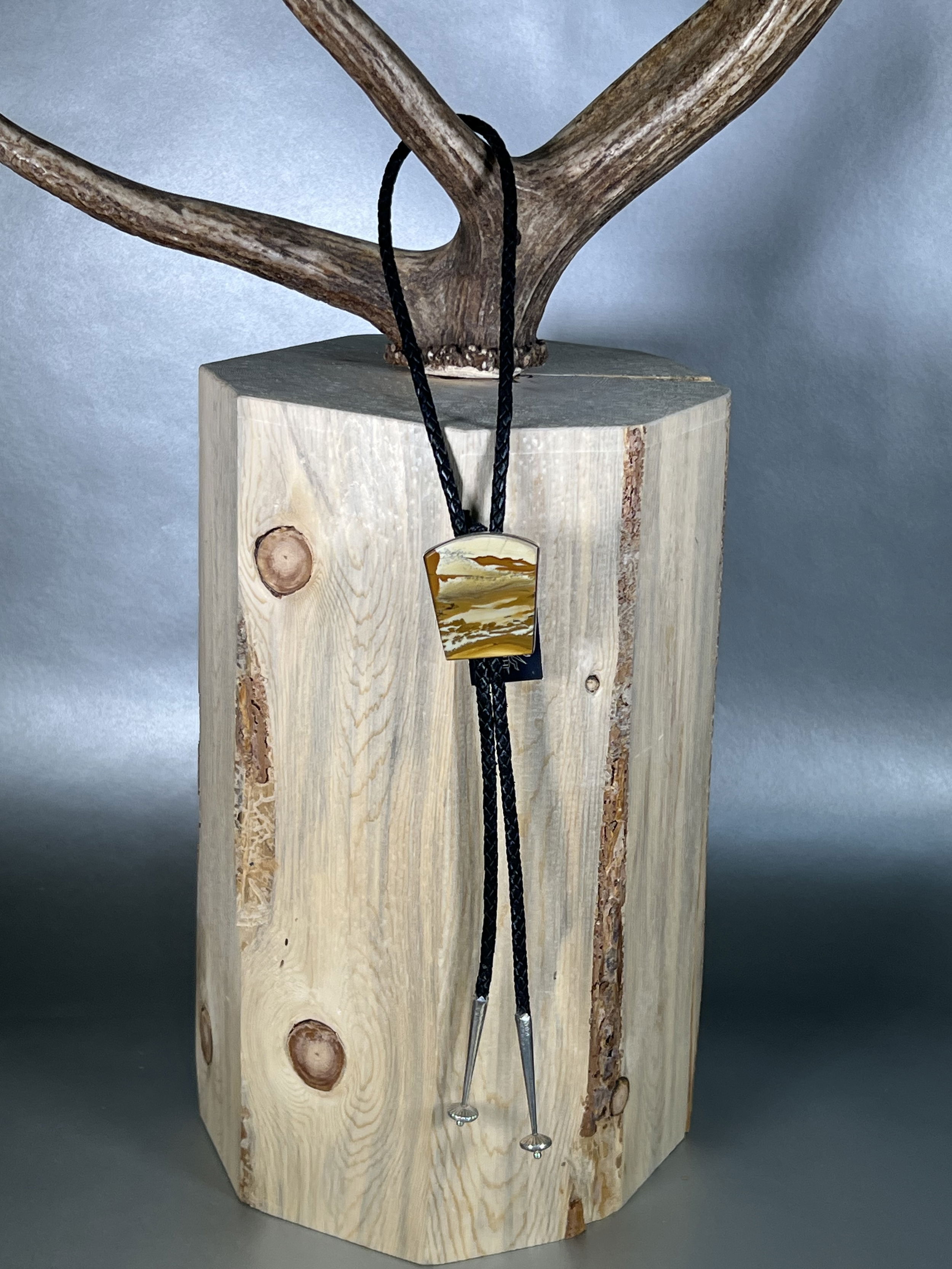 Elevate your style with our Owyhee Picture Bolo. Hand-crafted locally, this unique bolo tie features a stunning Picture Jasper stone portraying scenic Owyhee set in sleek, silver hardware. Add a touch of sophistication to any outfit with this luxurious accessory that will surely make a statement.-Sterling silver-Jasper-LeatherItem# 61426232 Owyhee Picture Jasper Bolo