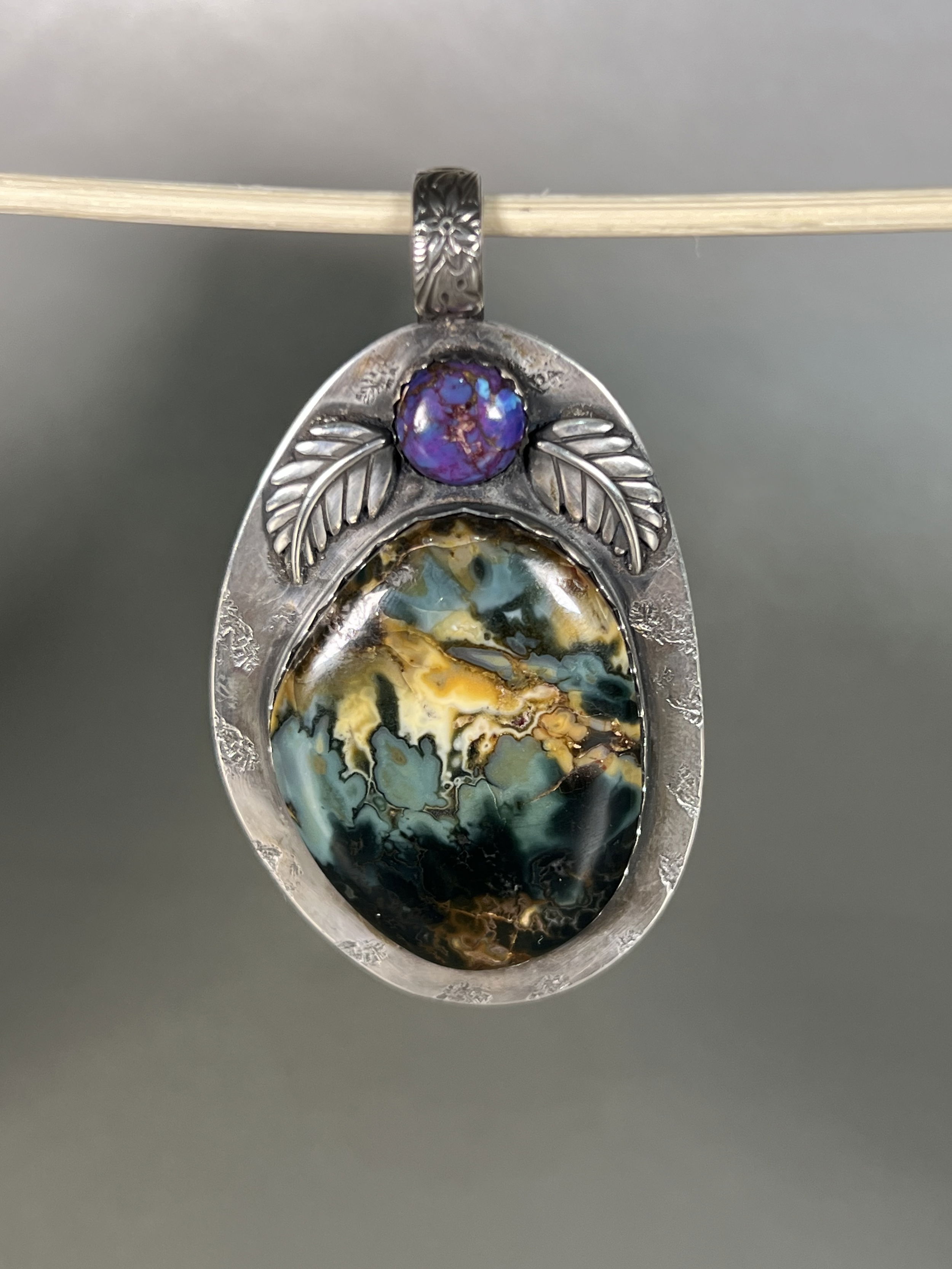 Indulge in the natural beauty of the Mackay Plume Agate Pendant. With agate mined and hand-crafted locally in Sun Valley Idaho, this one-of-a-kind piece boasts intricate details and a luxurious aesthetic. Elevate your style with this exclusive pendant and embrace the artistry and authenticity of local craftsmanship. Features a Midnight Magic Agate Plume.-Sterling silver-Agate-OpalItem# 22940728 Mackay Plume Agate Pendant