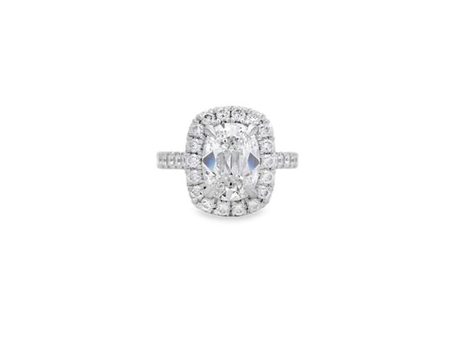 Designed by Henri Daussi, this engagement ring features an elongated cushion cut center diamond set in Platinum and surrounded by a brilliant halo of round diamonds that enhances its shape and sparkle. A refined and romantic design that blends timeless elegance with modern sophistication.-Platinum-Cushion Diamond, 2.51cts-Round Diamonds, 0.86cts-Size 6.25, Contact for sizing options Item# 100-2000050 Cushion 2.51ct Halo Engagement