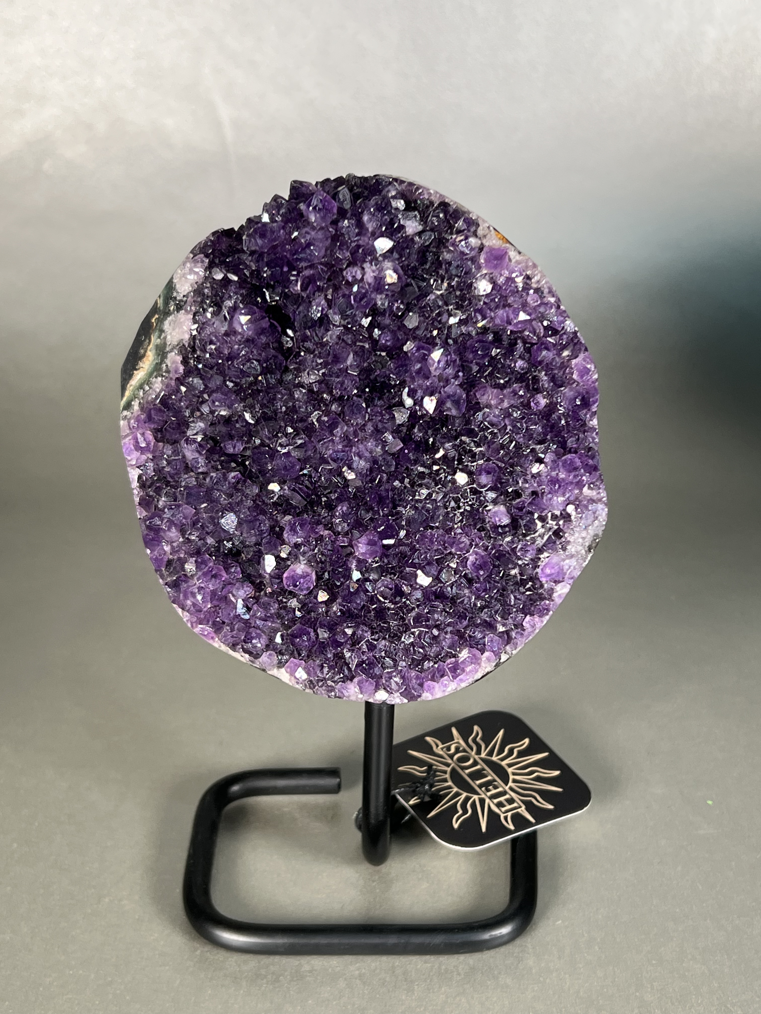 This amethyst on stand is the perfect addition to any home decor. Crafted with a premium natural amethyst crystal specimen and sturdy stand, this piece is sure to add a touch of elegance to any room. Its unparalleled beauty and durability make it a perfect long-term home accessory. Approx. 5" x 8" Uruguayan Amethyst On Stand