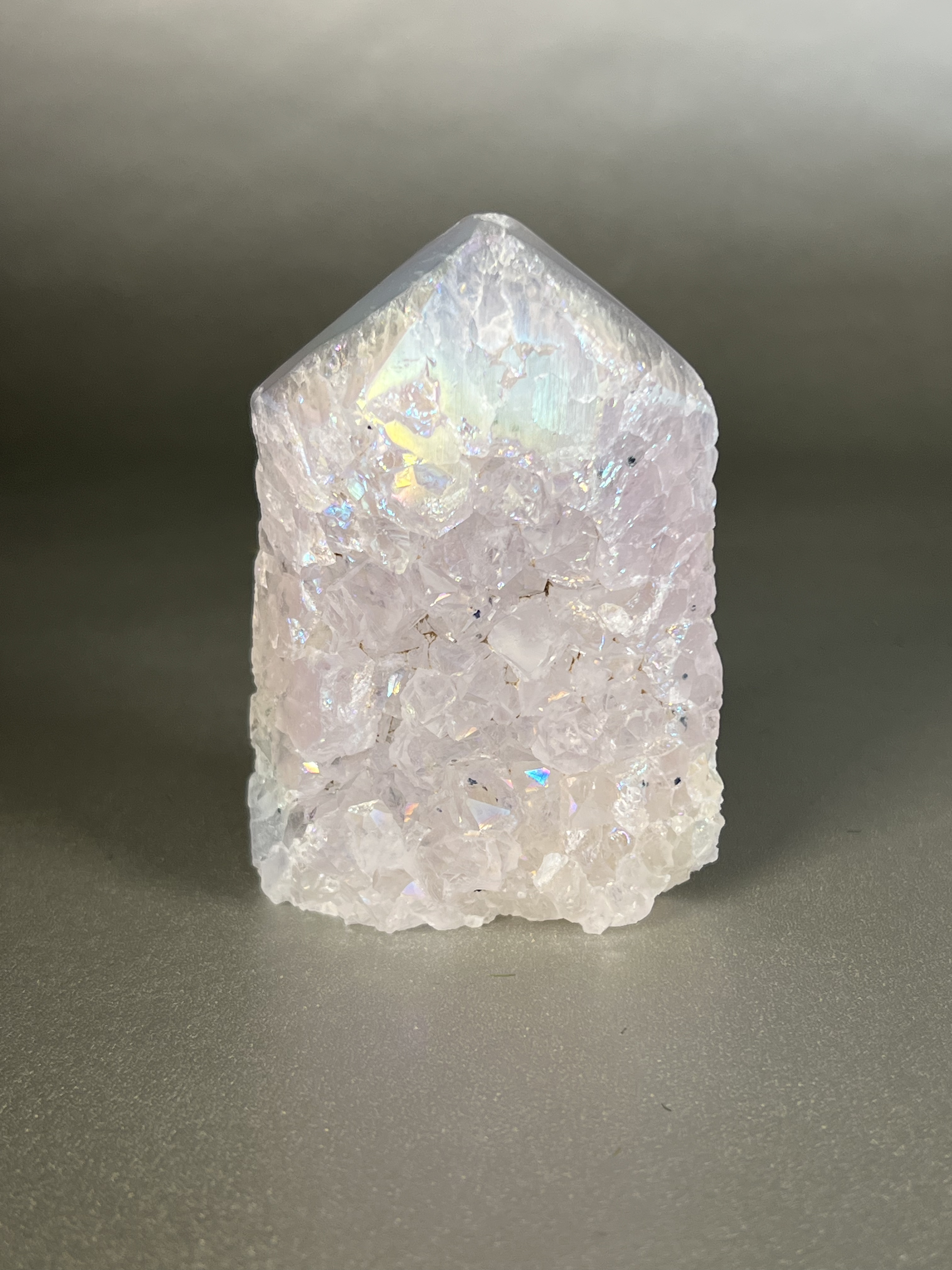 Experience the dreamy elegance of our Aura Agate Obelisk. Each one is uniquely crafted to exude a sense of luxury and exclusivity. Featuring the rare Aura Agate stone, this obelisk brings a touch of sophistication and beauty to any space. Elevate your decor with this truly one-of-a-kind piece. Approx. 2.5"x3.5" Aura Agate Tower