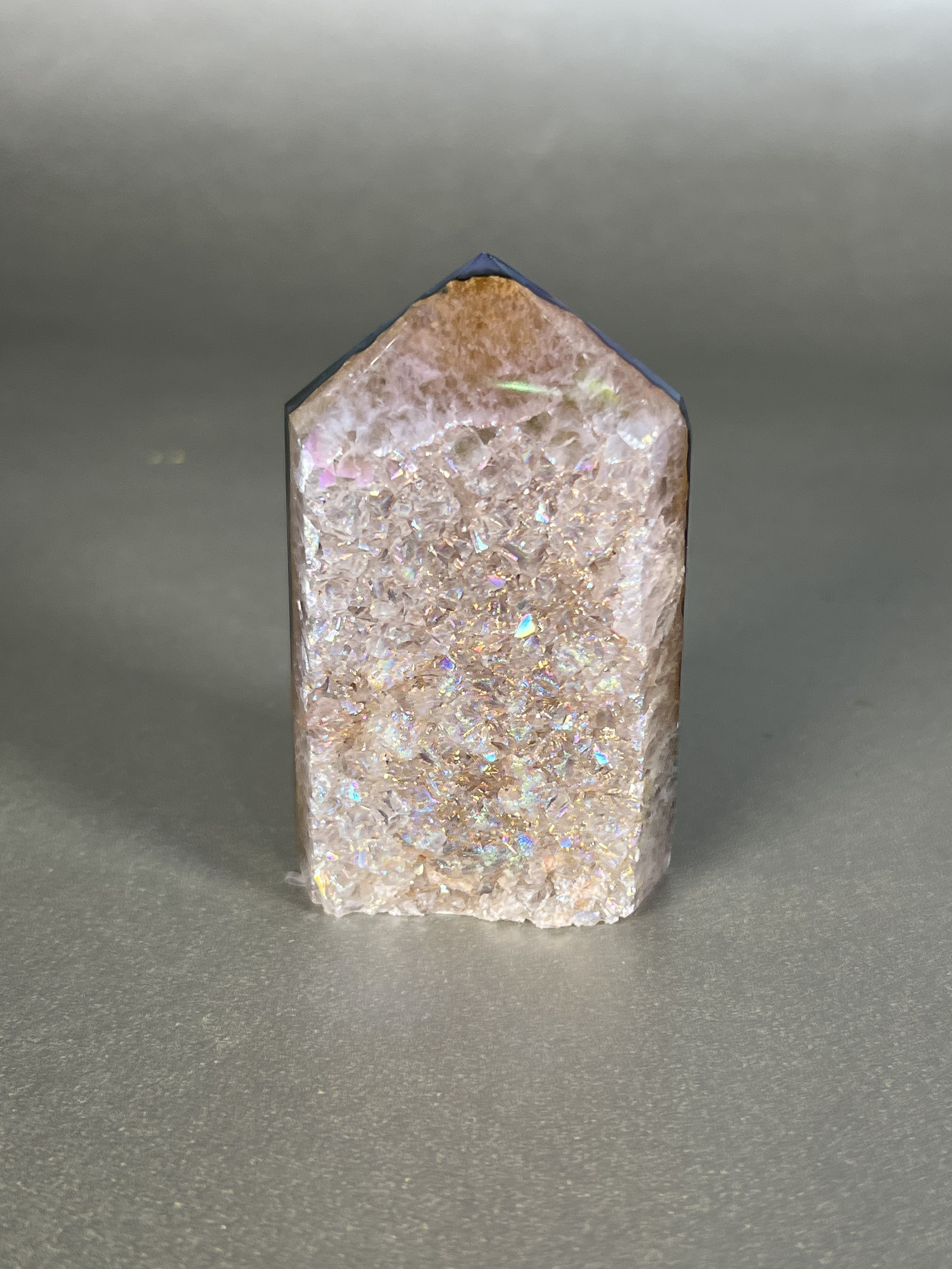 Experience the dreamy elegance of our Aura Agate Obelisk. Each one is uniquely crafted to exude a sense of luxury and exclusivity. Featuring the rare Aura Agate stone, this obelisk brings a touch of sophistication and beauty to any space. Elevate your decor with this truly one-of-a-kind piece. Approx. 2" x 3" Aura Agate Tower