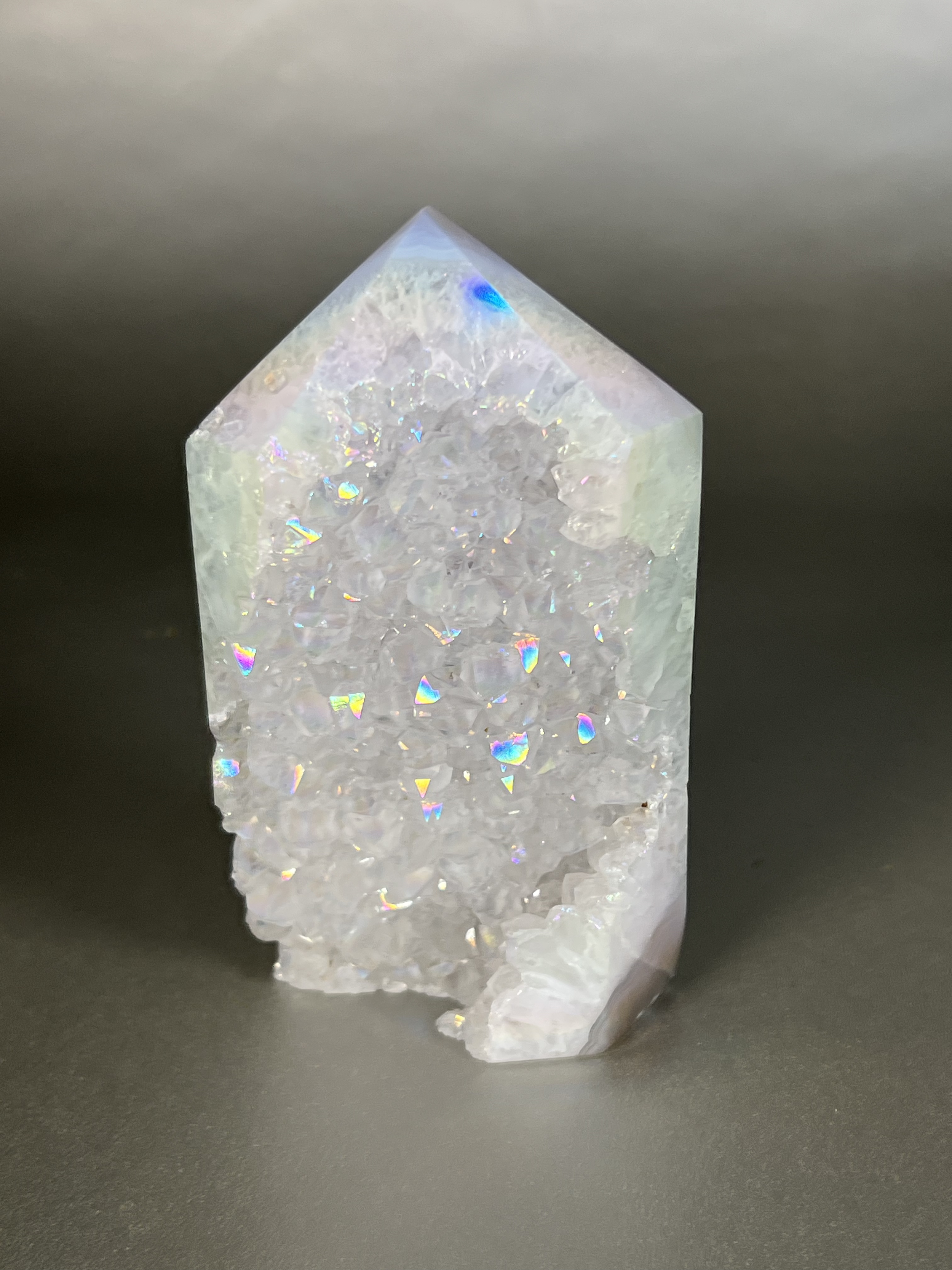 Experience the dreamy elegance of our Aura Agate Obelisk. Each one is uniquely crafted to exude a sense of luxury and exclusivity. Featuring the rare Aura Agate stone, this obelisk brings a touch of sophistication and beauty to any space. Elevate your decor with this truly one-of-a-kind piece. Approx. 2.5" x 4.5" Aura Agate Tower