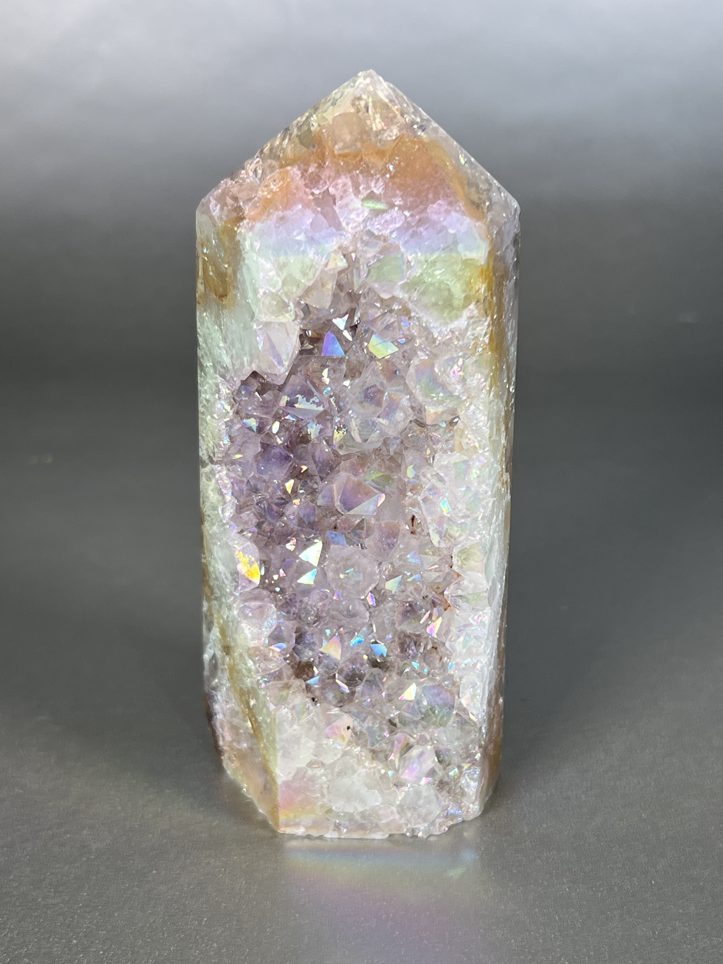 Experience the dreamy elegance of our Aura Agate Obelisk. Each one is uniquely crafted to exude a sense of luxury and exclusivity. Featuring the rare Aura Agate stone, this obelisk brings a touch of sophistication and beauty to any space. Elevate your decor with this truly one-of-a-kind piece. Approx. 2" x 5.5" Aura Agate Tower