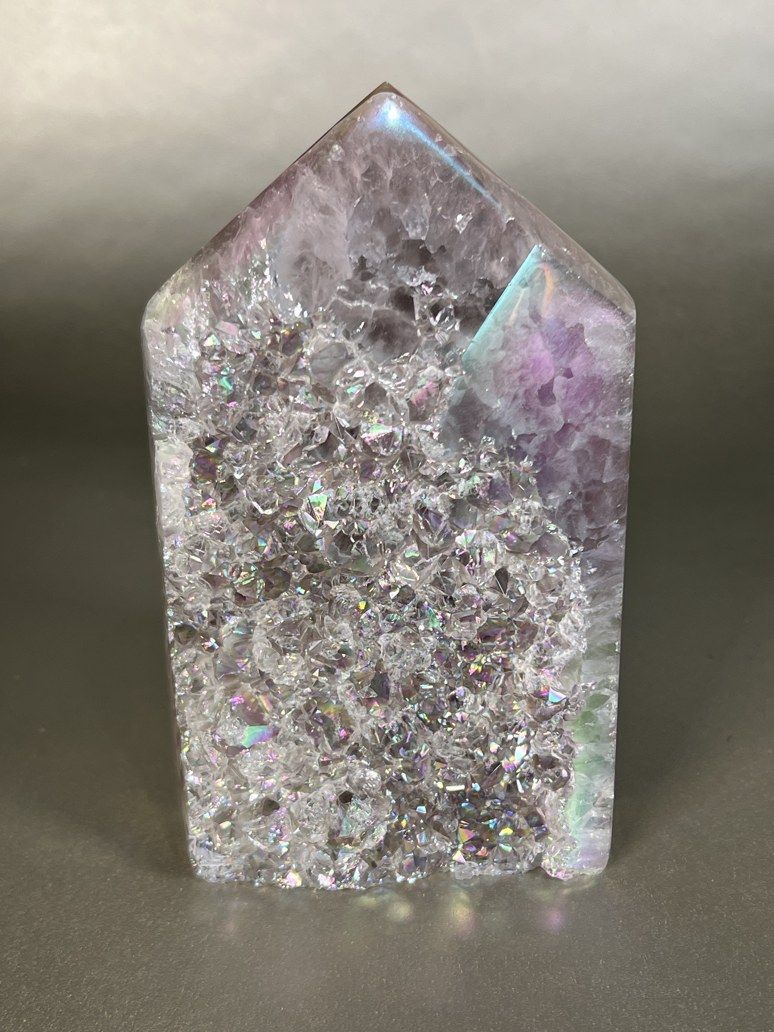 Experience the dreamy elegance of our Aura Agate Obelisk. Each one is uniquely crafted to exude a sense of luxury and exclusivity. Featuring the rare Aura Agate stone, this obelisk brings a touch of sophistication and beauty to any space. Elevate your decor with this truly one-of-a-kind piece. Approx. 3.5"x5.5" Aura Agate Tower