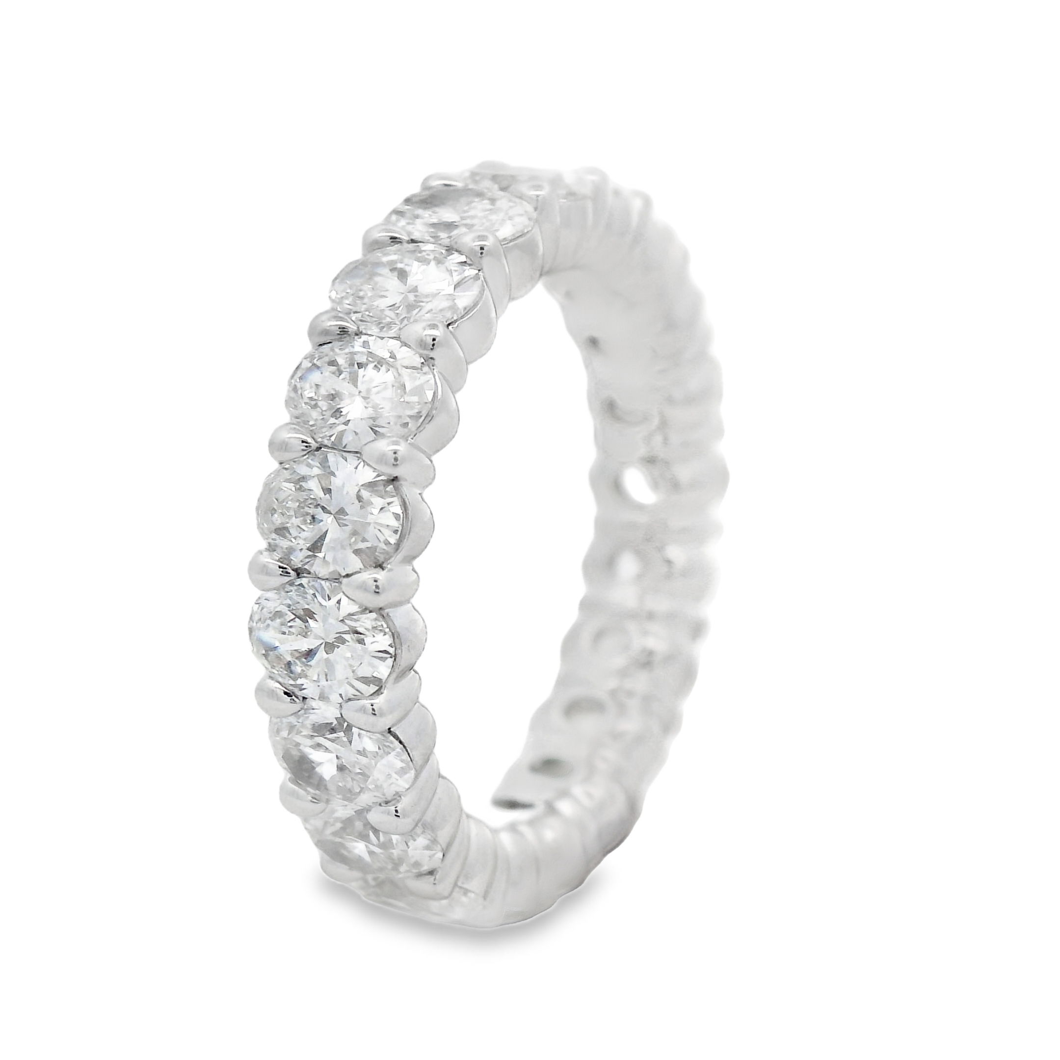 This 18k white gold anniversary band features oval diamonds set in a unique "buttercup" setting, enhancing their brilliance with a timeless and elegant design. A perfect way to celebrate your love, this band adds a sophisticated touch to any engagement ring.-18k White gold-Oval diamonds, 3.91cts-Size 6, Contact for sizing optionsItem# 130-2000048 Oval Buttercup Eternity Band