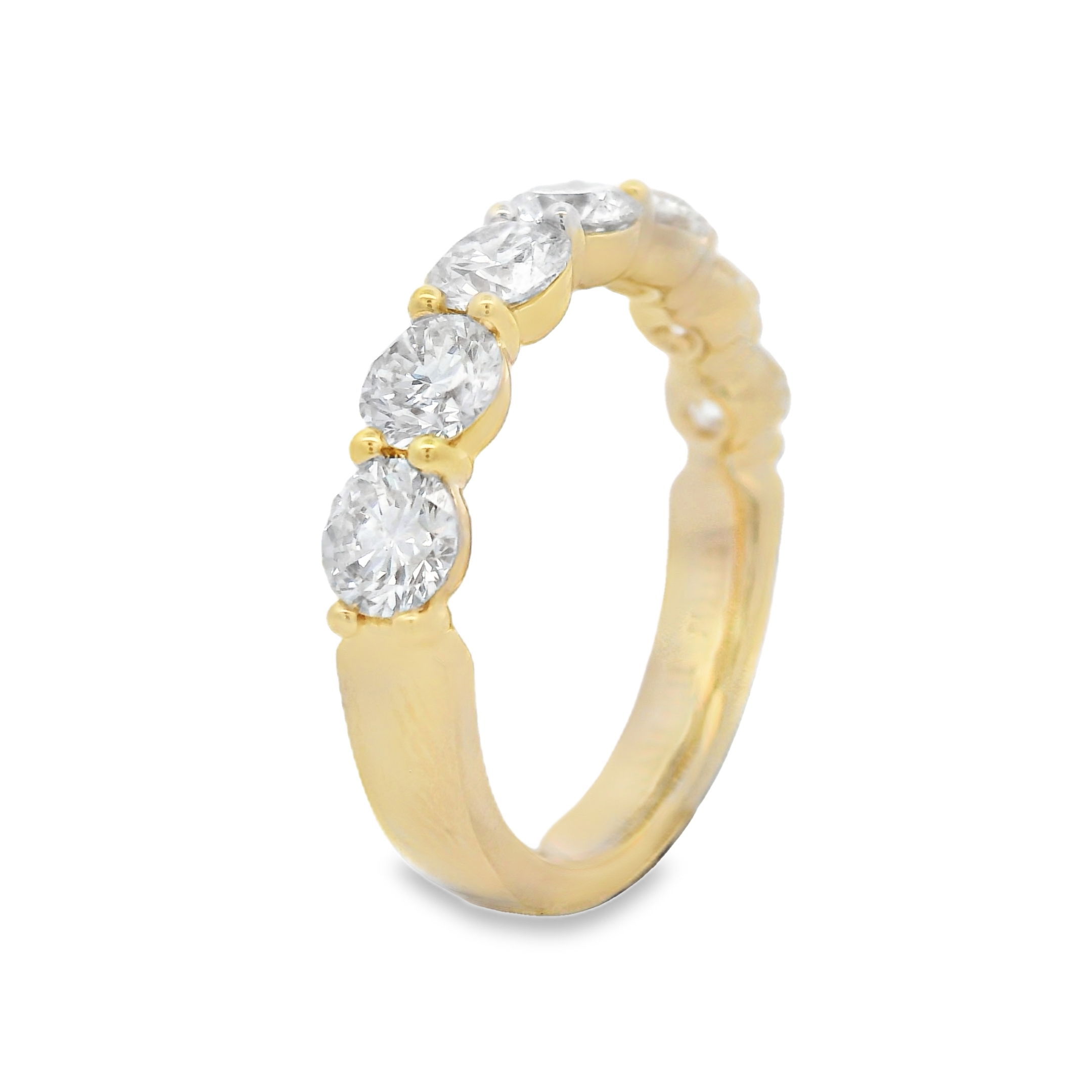 This 18k yellow gold anniversary band features round diamonds set in a unique "buttercup" setting, enhancing their brilliance with a timeless and elegant design. A perfect way to celebrate your love, this band adds a sophisticated touch to any engagement ring.-18k Yellow gold-Round diamonds, 1.87cts-Size 6, Contact for sizing optionsItem# 130-2000050 Round Buttercup Band