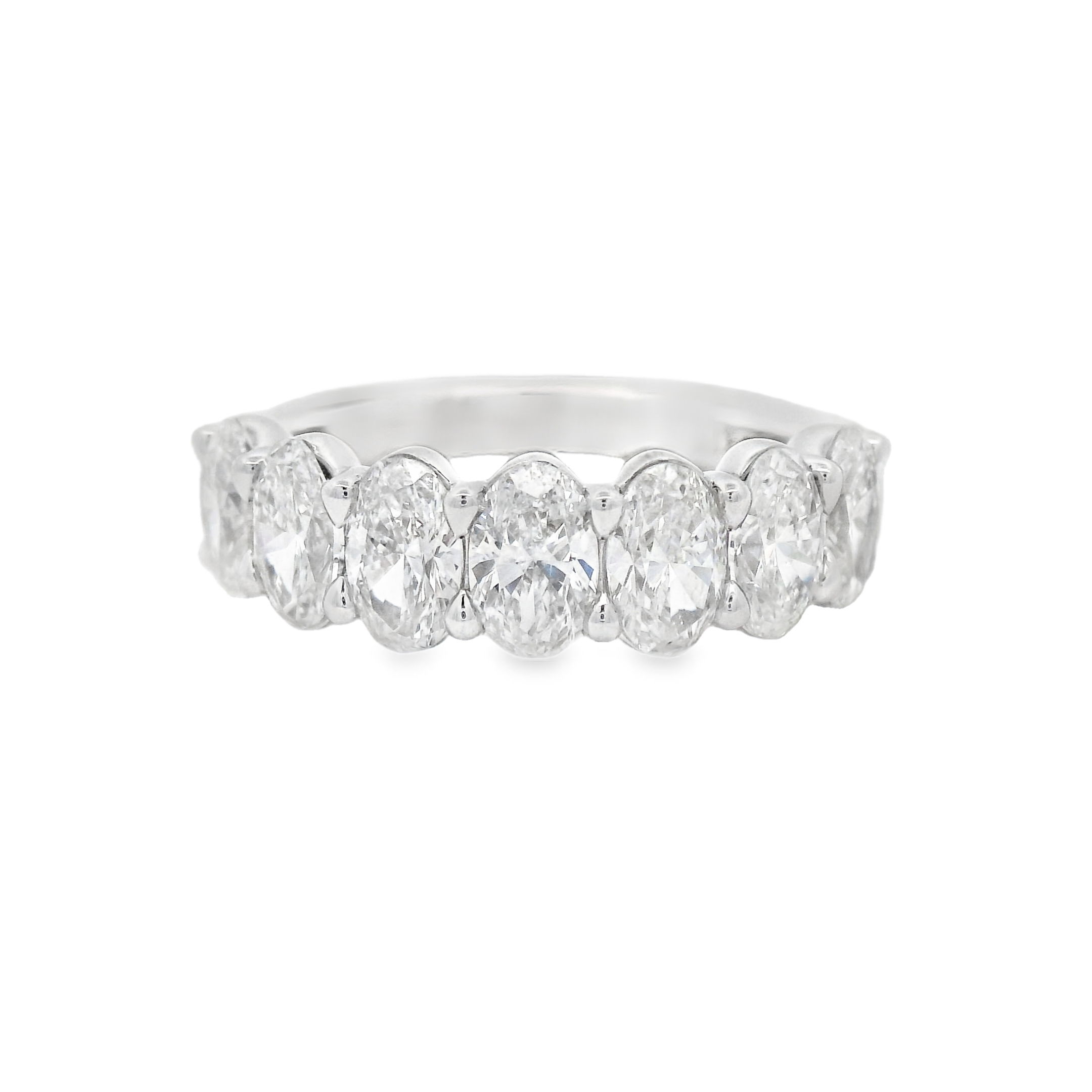 This 18k white gold anniversary band features oval diamonds set in a unique "buttercup" setting, enhancing their brilliance with a timeless and elegant design. A perfect way to celebrate your love, this band adds a sophisticated touch to any engagement ring.-18k White gold-Oval diamonds, 2.23cts-Size 6, Contact for sizing optionsItem# 130-2000052 Oval Buttercup Band