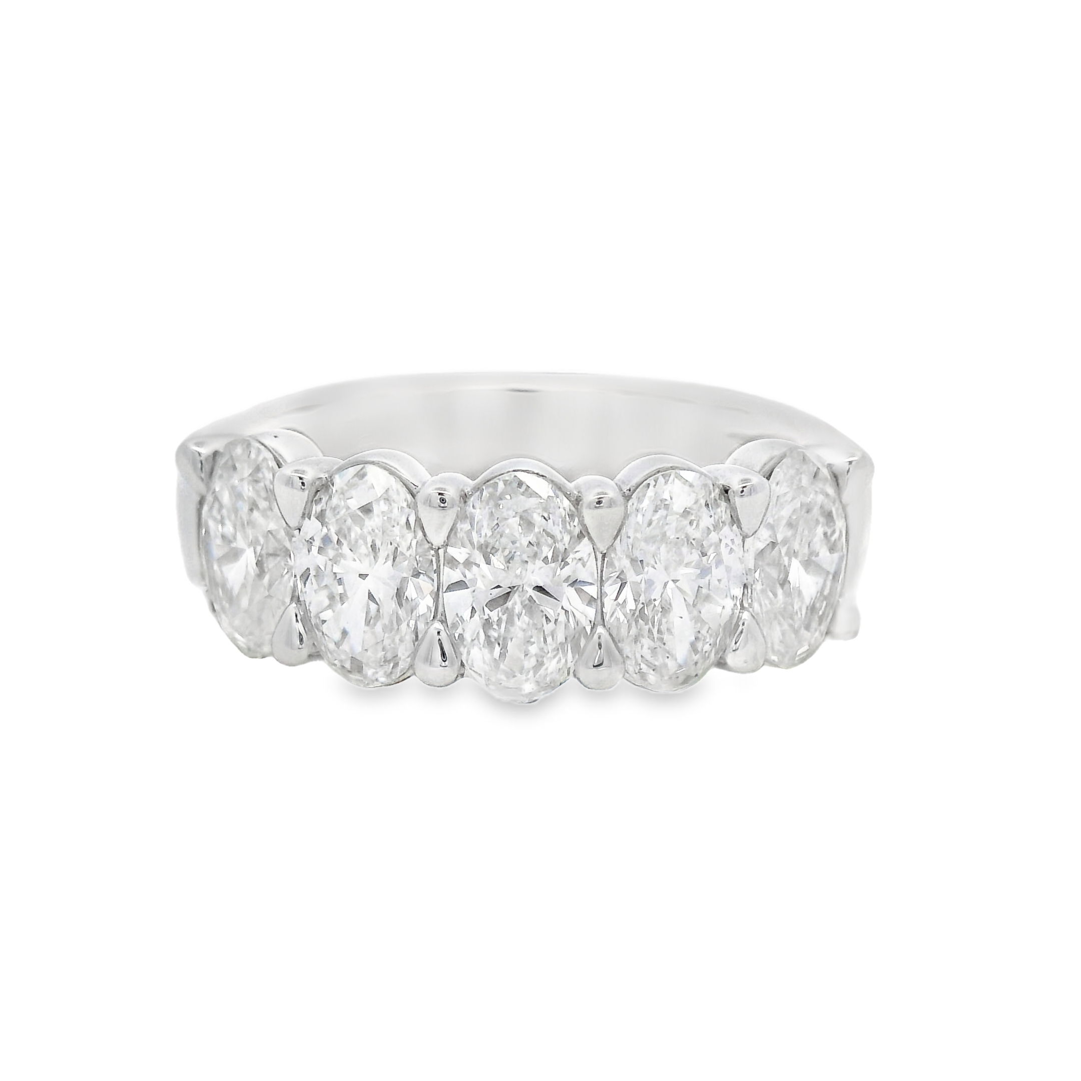 This 18k white gold anniversary band features oval diamonds set in a unique "buttercup" setting, enhancing their brilliance with a timeless and elegant design. A perfect way to celebrate your love, this band adds a sophisticated touch to any engagement ring.-18k White gold-Oval diamonds, 2.52cts-Size 6, Contact for sizing optionsItem# 130-2000053 Oval Buttercup Band