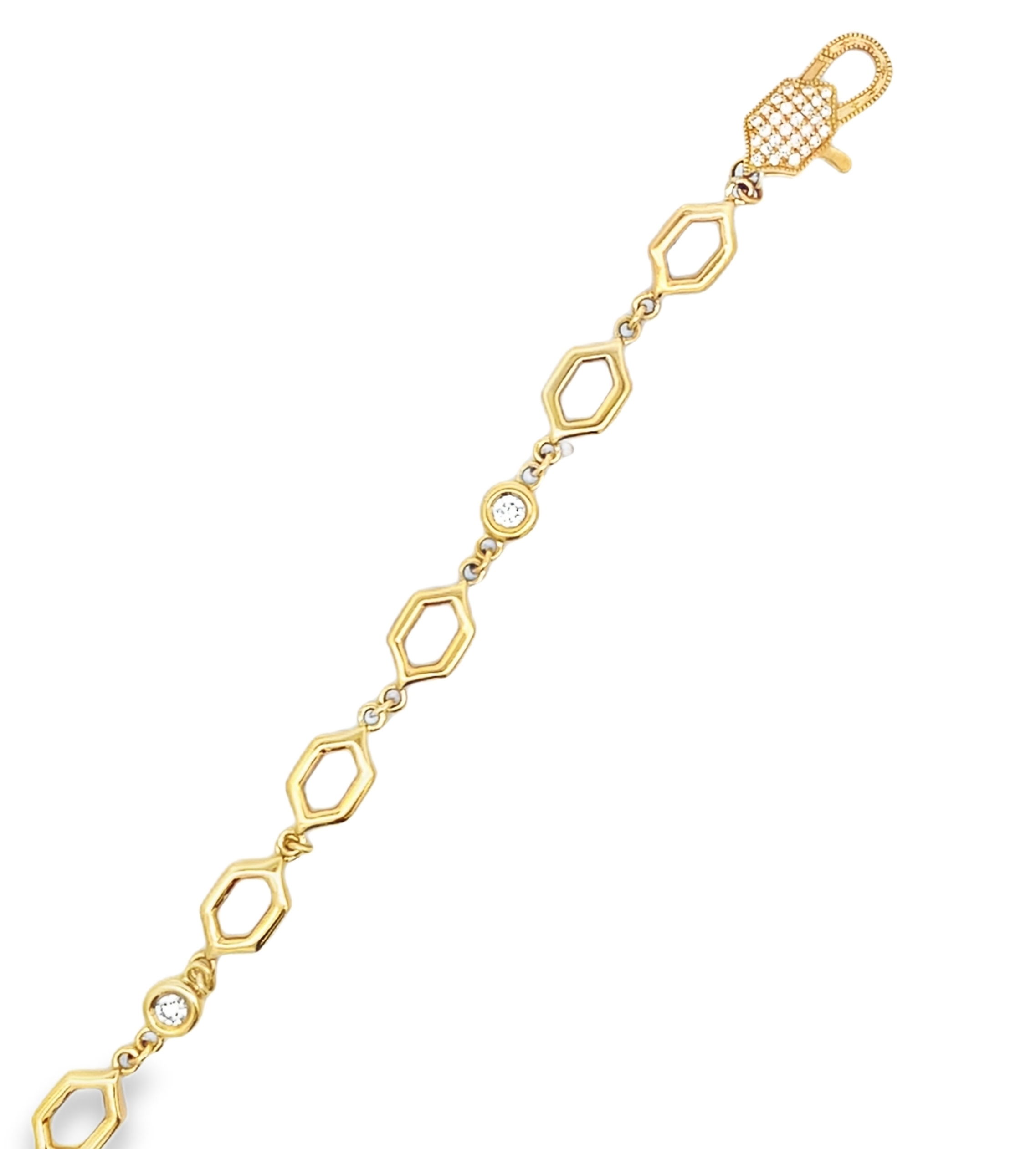 Crafted in 18k yellow gold, this bracelet features geometric hexagon links accented with 0.75cts of round bezel-set diamonds. The modern design and subtle sparkle make it a versatile piece with timeless appeal.-18k Yellow gold -Diamonds, F-G/VS 0.75ctsItem# 240-2000032 Diamond Hex Bracelet