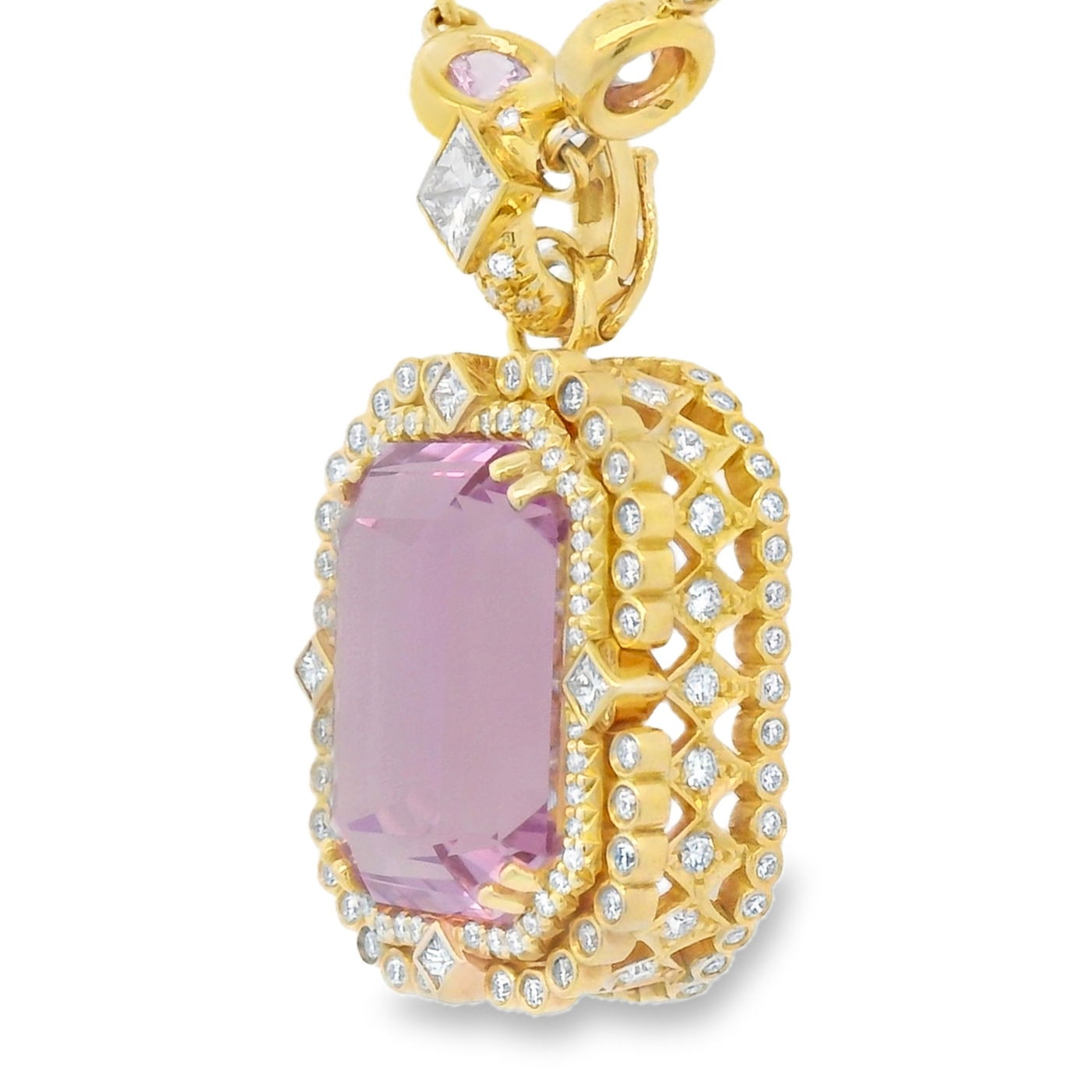 Crafted in rich 18k yellow gold, this pendant showcases a captivating 23.64ct kunzite stone at its center—known for its delicate pink hue and dazzling clarity. A generous halo of sparkling diamonds surround the gemstone, adding timeless sophistication and exceptional brilliance. Chain sold separately. -18k Yellow gold -Kunzite, 23.64ct -Diamonds, F-G/VS 1.93ctsItem# 230-2000015 Blushing Halo Pendant