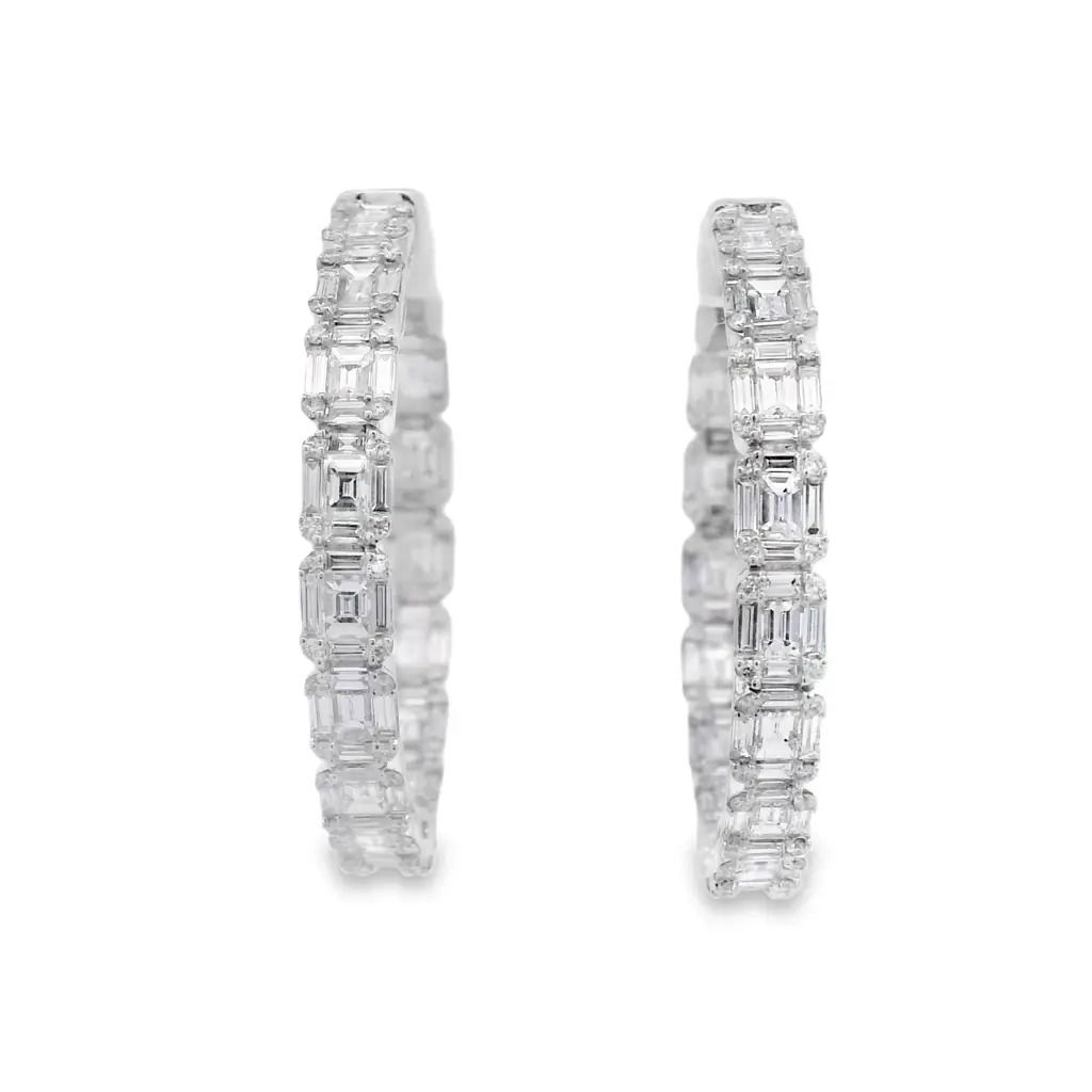 Discover the allure of these stunning 18K white gold diamond hoop earrings, designed to elevate any outfit. Crafted with precision, each earring features a series of sparkling emerald-cut diamonds that catch the light beautifully. Perfect for both casual outings and formal events, these earrings are a must-have addition to your jewelry collection. -18k White gold-Round and Baguette diamonds, 3.90ctsItem# 150-2000123 Illusion Hoops 1.25"
