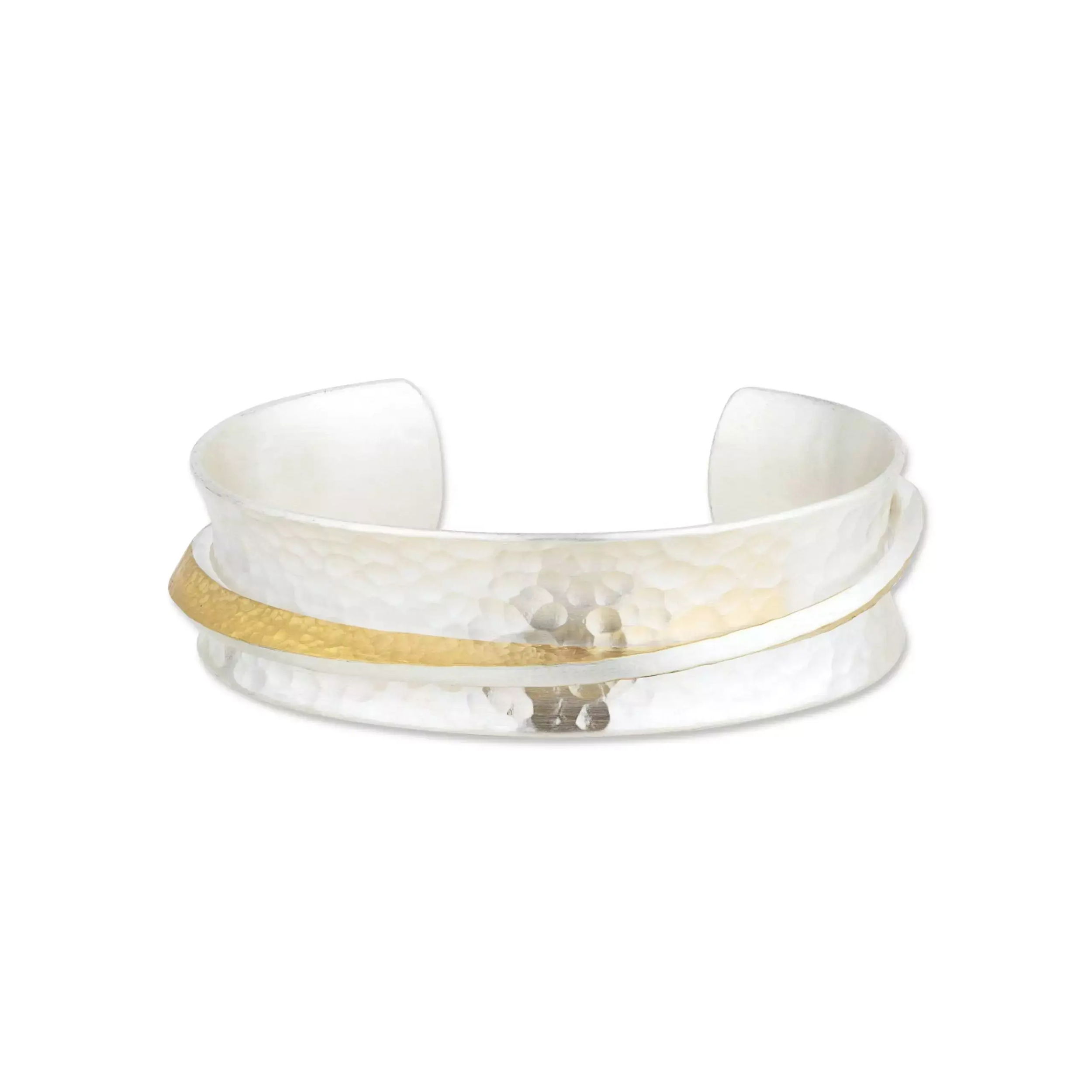 The “Twist” cuff blends hammered 24K fusion gold with sterling silver in a fluid, open design. With a refined 17mm width, this piece makes a bold yet elegant statement—modern craftsmanship with timeless appeal.-Sterling silver-24k Fusion goldItem# 808-2000306 Twist Open Cuff