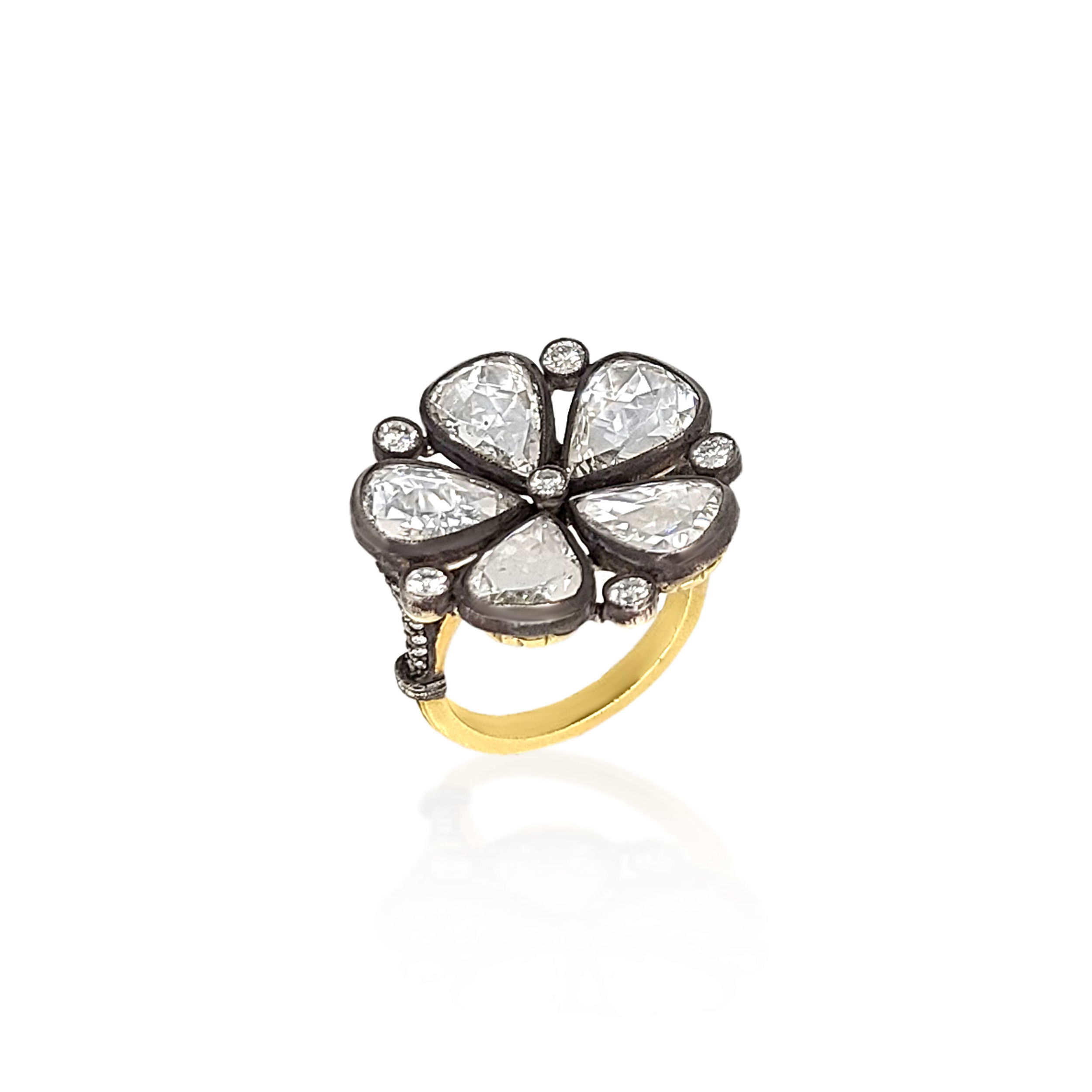 Delicately dramatic, this ring features a pear-shaped design adorned with multiple rose-cut diamonds, offering a romantic shimmer with vintage-inspired charm. Norman Covan's Rose Cut Collection is a rare, one-of-a-kind offering of vintage stones hand-set into heirloom-quality pieces that blend historic craftsmanship with modern elegance.-18k Yellow gold-Oxidized silver-Diamonds, 5.71cts-Contact for sizing options.Item# 804-2000350 Pear Shaped Multi Rose Cut Diamond Ring