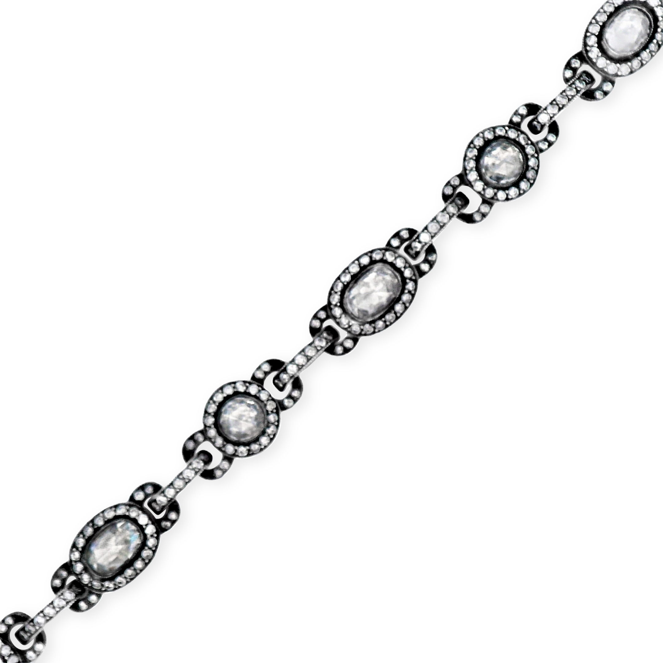 Norman Covan's 18KY & Oxidized Silver Oval and Round Shaped Rose-Cut Diamond bracelet, showcases a rare and storied craftsmanship, reviving the centuries-old mirror-back setting mastered by only a select few artisans. This intricate technique, a hand-polished silver reflector is placed within a closed-back mounting beneath the antique rose-cut diamond, allowing light to enter through the domed facets, reflect from below, and return with a soft, inner glow that radiates timeless elegance.-18k Yellow gold-Oxidized silver-Diamonds, 3.98ctsItem# 804-2000326 Rose Cut Diamond Bracelet