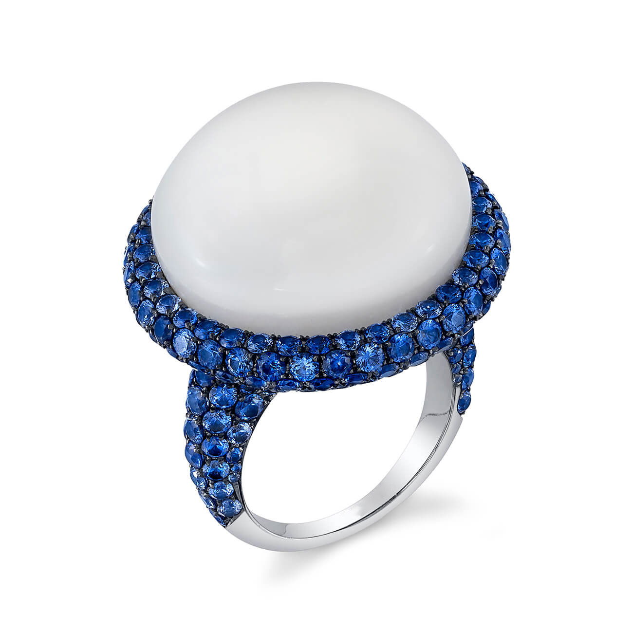 Elevate your elegance with this Clam Pearl and Sapphire Cocktail Ring, expertly crafted in 18k white gold. A timeless blend of natural beauty and refined design, it’s a statement piece for those who appreciate rare sophistication. Cicada atelier is located in the heart of the New York City jewelry district on 47th street, where each unique piece is meticulously handcrafted.-18k White gold-Clam pearl, 52.73cts-Blue sapphire, 9.05ctsItem# 200-2000170 Clam Pearl and Sapphire Cocktail Ring