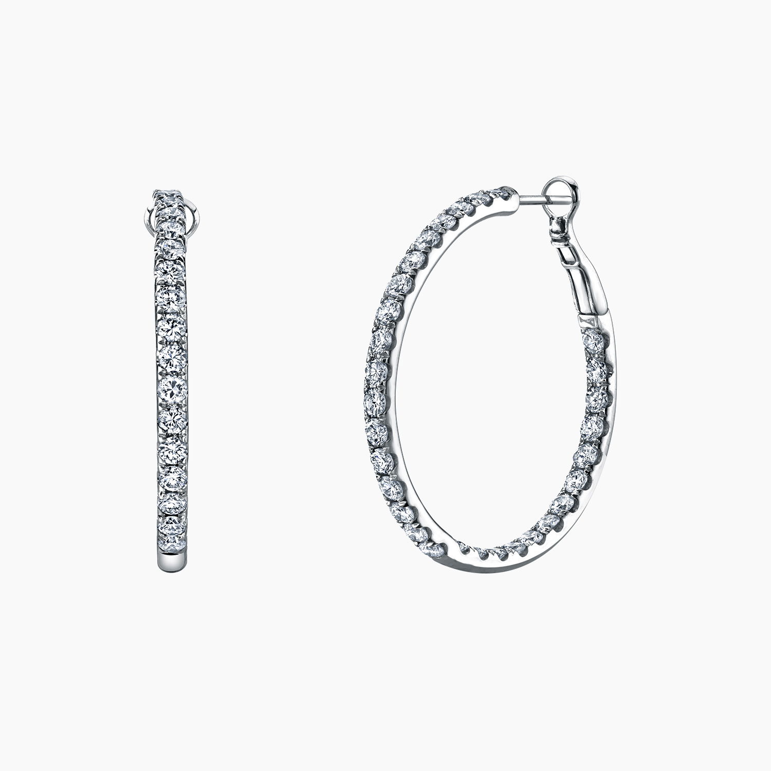 Each hoop sparkles with a row of hand-selected brilliant-cut diamonds, offering timeless sophistication and radiant shimmer. Secured with a comfortable hinge closure, these earrings are the perfect blend of classic beauty and modern luxury—ideal for both everyday glamour and unforgettable occasions.-18k White gold-Round diamonds, 4.81ctsItem# 150-2000135 Diamond Hoop Earrings