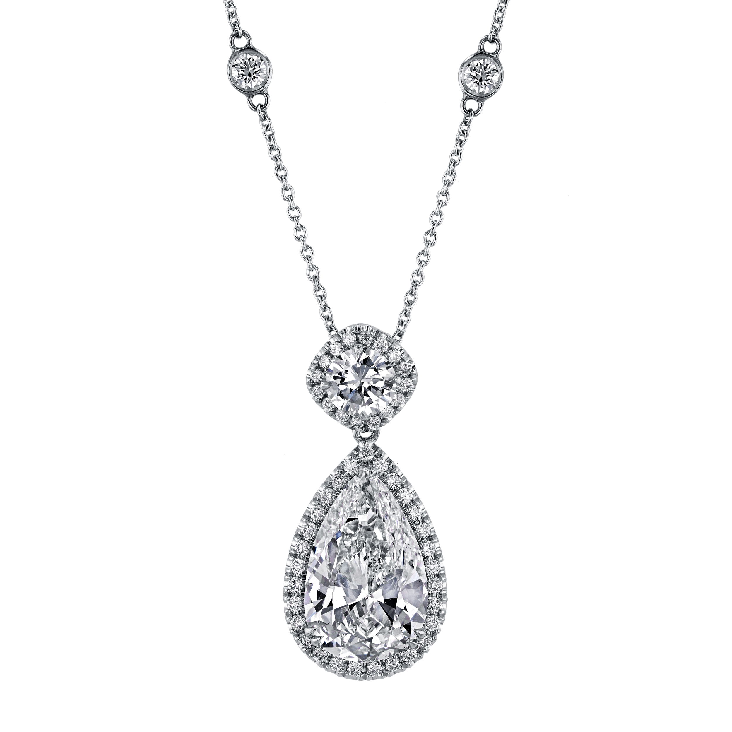 This stunning piece features a dazzling pear-shaped diamond, gracefully suspended to capture and reflect light from every angle. Surrounded by a halo of meticulously set accent diamonds, the pendant glimmers with exceptional brilliance. -18k White gold-Pear diamond, 1.52cts-Round diamonds, 1.05cts-Length, 16"-17" on adjustable chainItem# 165-2000068 Diamond Pear Necklace