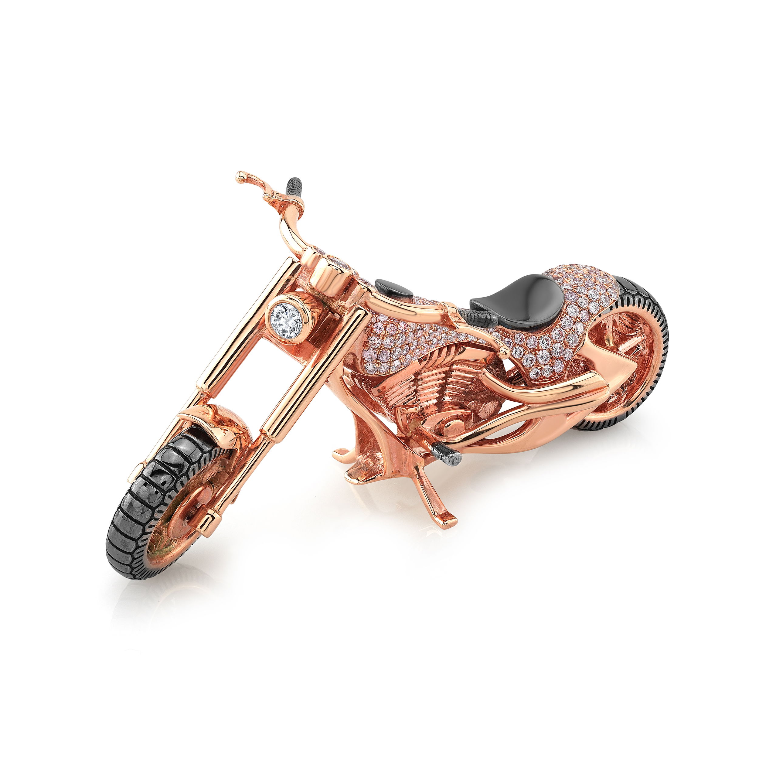 Crafted in 18k rose gold, this unique motorcycle collectible is a bold and luxurious gift item. Featuring over a carat of vibrant pink diamonds, it combines fine craftsmanship with playful design. Perfect for the collector or enthusiast, it's a striking piece that blends splendor with personality.-18k Rose gold -Pink diamonds, 1.063cts-Round diamonds, 0.10cts Motorcycle with Pink Diamonds