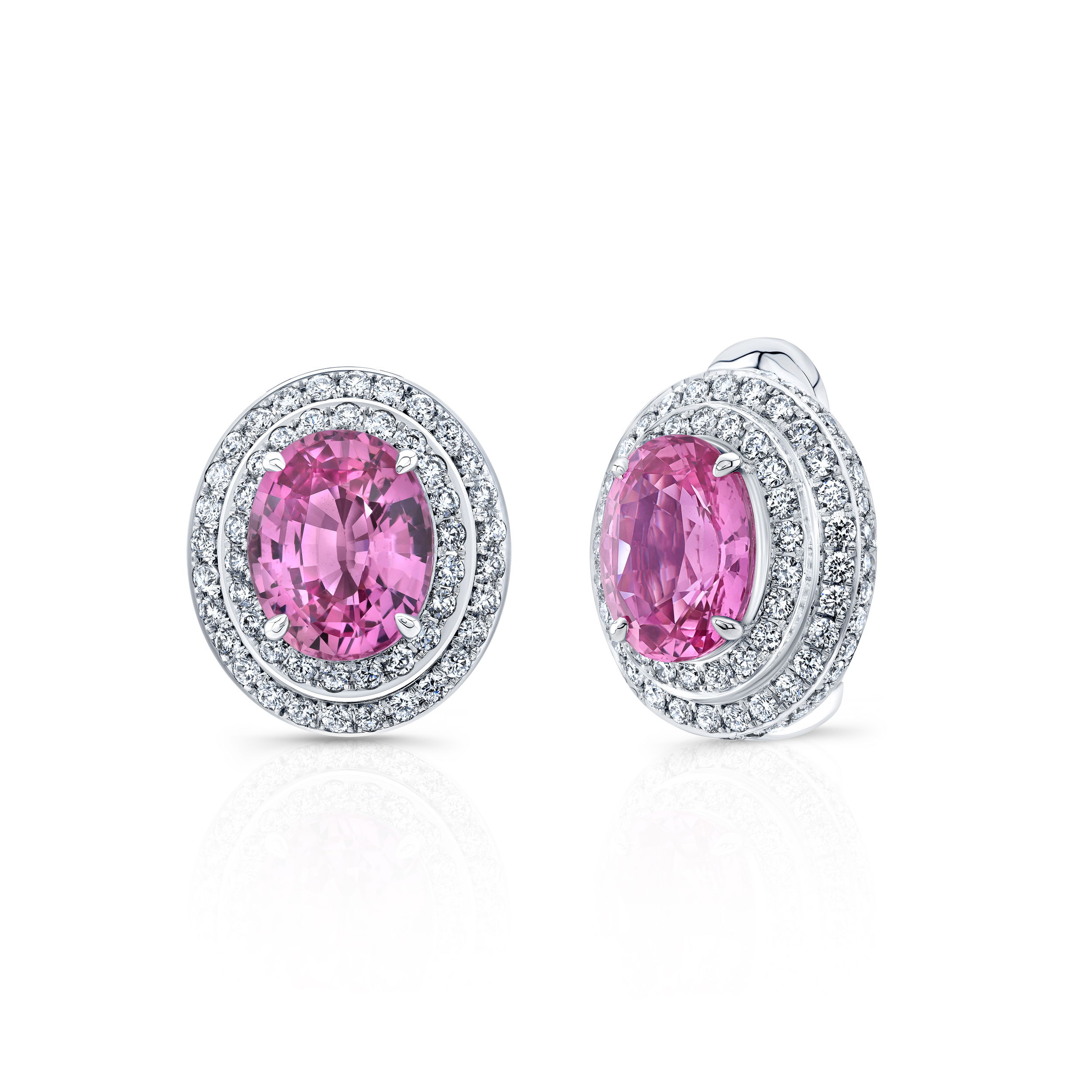These platinum earrings feature vibrant oval-shaped pink sapphires, each surrounded by a sparkling halo of diamonds. Elegant and feminine, they offer timeless beauty with a touch of modern charm.-Platinum -Pink sapphires, 8.14cts-Diamonds, 1.95ctsItem# 210-2000096 Oval Pink Sapphire Earrings