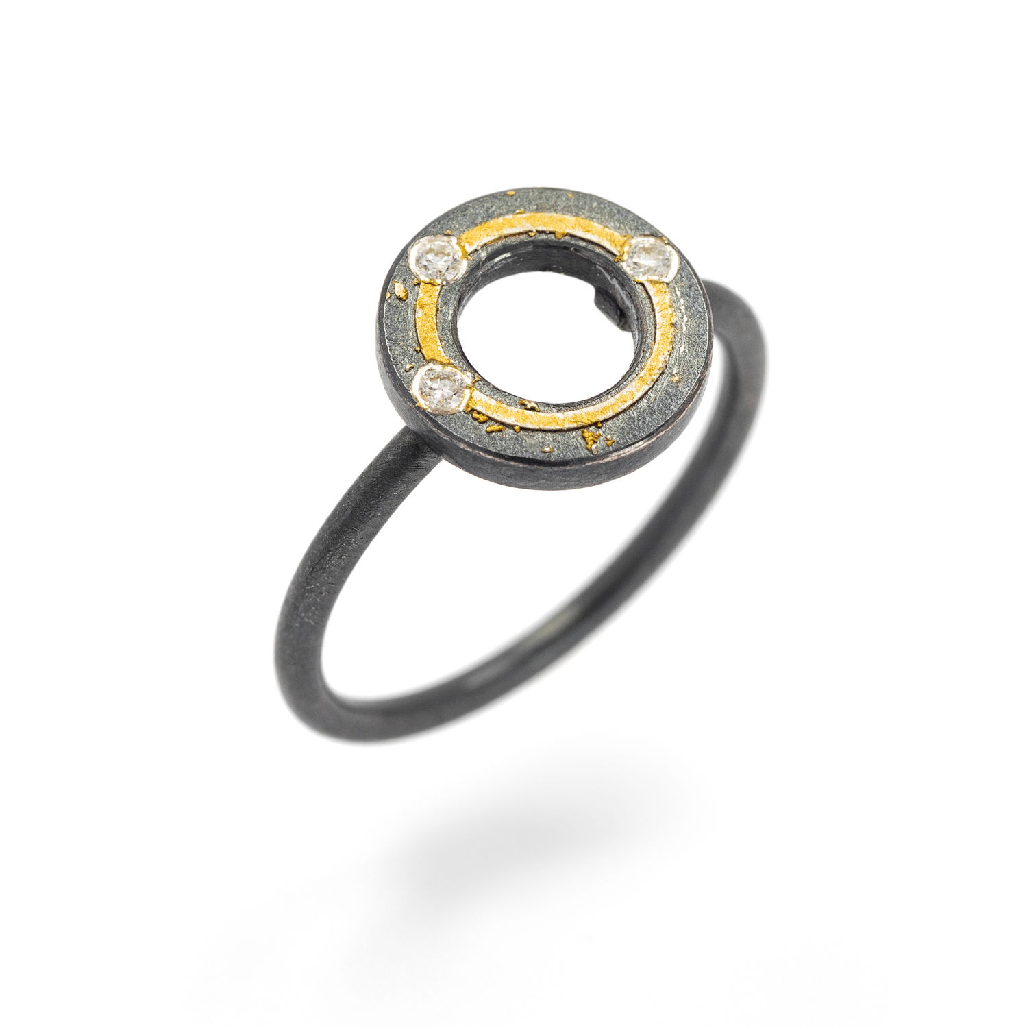 This sculptural ring features a bold 'O' motif in oxidized sterling silver, accented with hand-applied 24k yellow gold and set with shimmering white diamonds. Minimal in form but rich in texture, it’s a quiet statement with soulful depth.-Sterling silver and 24k yellow gold-Round diamonds, 0.03cts Item# 804-2000356 'Hugs' Ring