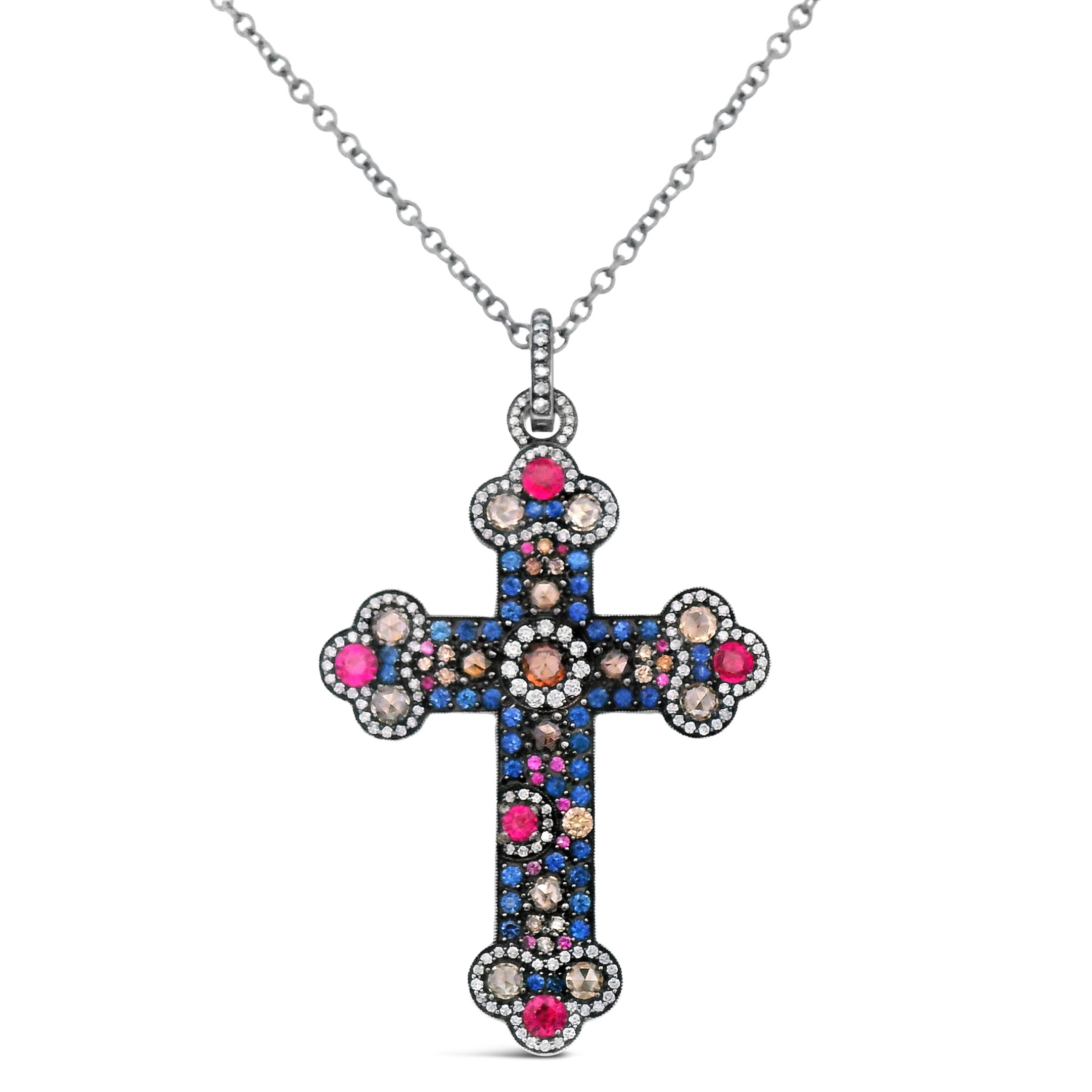Crafted from rich 18k yellow gold, this cross pendant features a delicate design accented with brilliant diamonds and captivating sapphires. It’s a meaningful and luxurious piece perfect for adding a touch of grace to any outfit. Chain sold separately.-18k Yellow gold-Diamonds, 0.96-Sapphires, 5.00ctsItem# 806-2000197 Sapphire and Cognac Diamond Cross