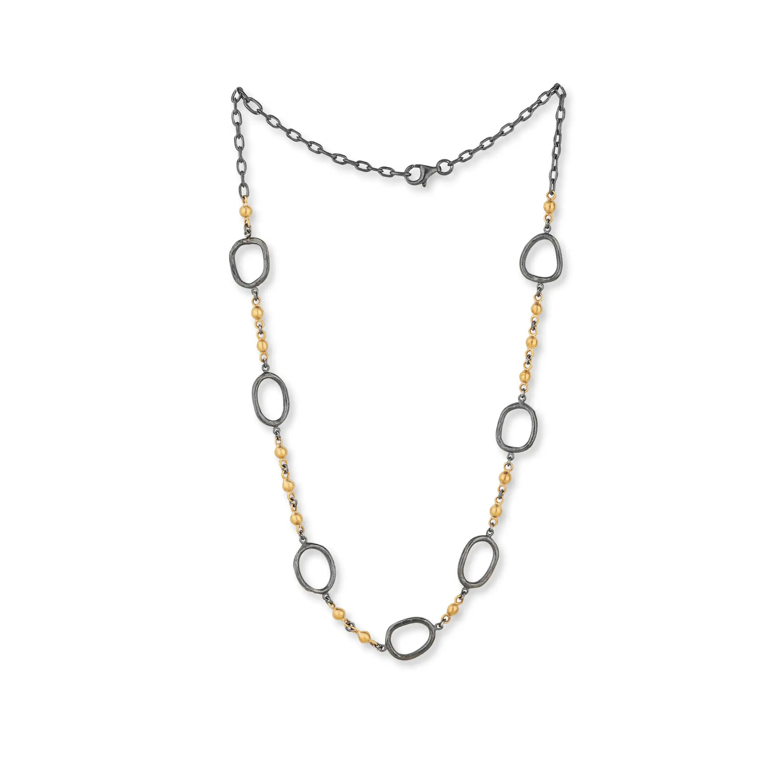 This striking necklace pairs rich 22k gold with deep oxidized silver for a bold yet refined look. Featuring a central “Reflections Ball” and seven oxidized silver links, it’s a thoughtful balance of contrast and craftsmanship.-Oxidized silver-22k Yellow gold-Length 18"Item# 807-2000428 Reflection Ball Necklace