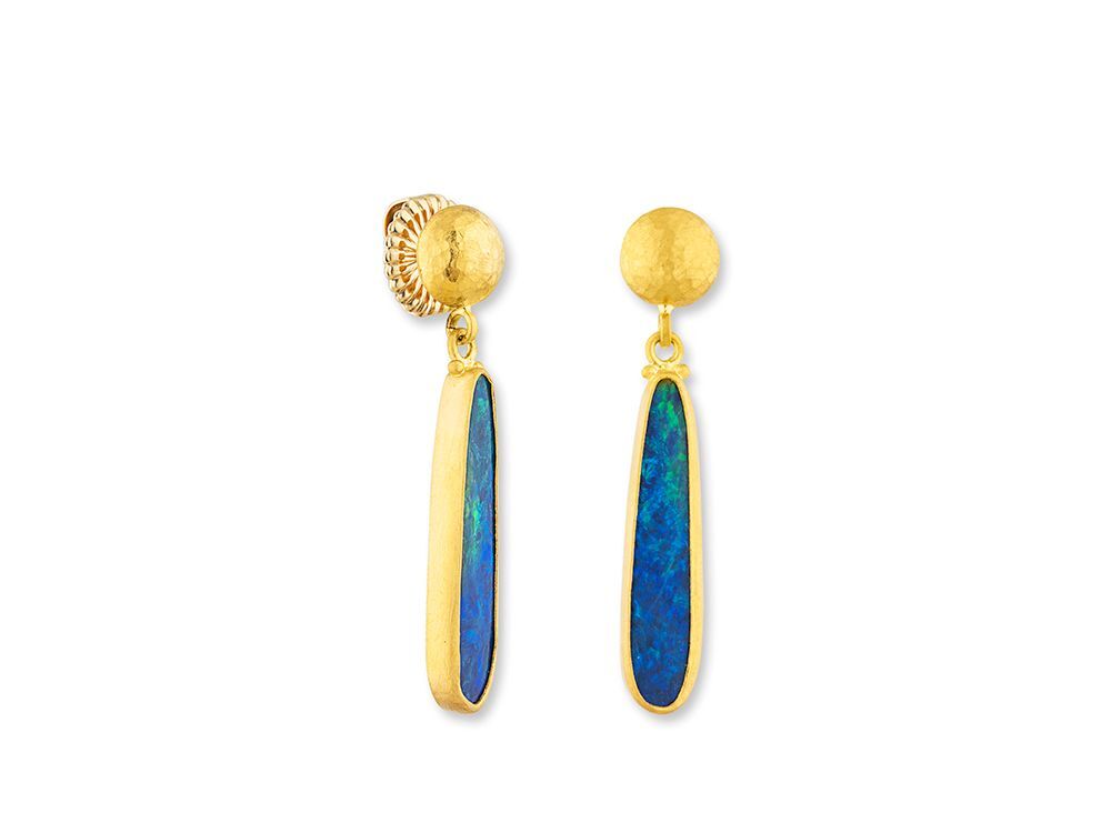 Make waves with the Ocean earrings—truly one of a kind. These striking earrings feature vibrant opal doublets set in rich 24k gold, with smooth button tops for a bold yet elegant finish. Capture the fluid beauty of the sea in every shimmering hue these are artful, rare, and unforgettable.-Opal doublet, 5x24mm, 6.06cts-24k Yellow goldItem# 805-2000591 Ocean Earrings